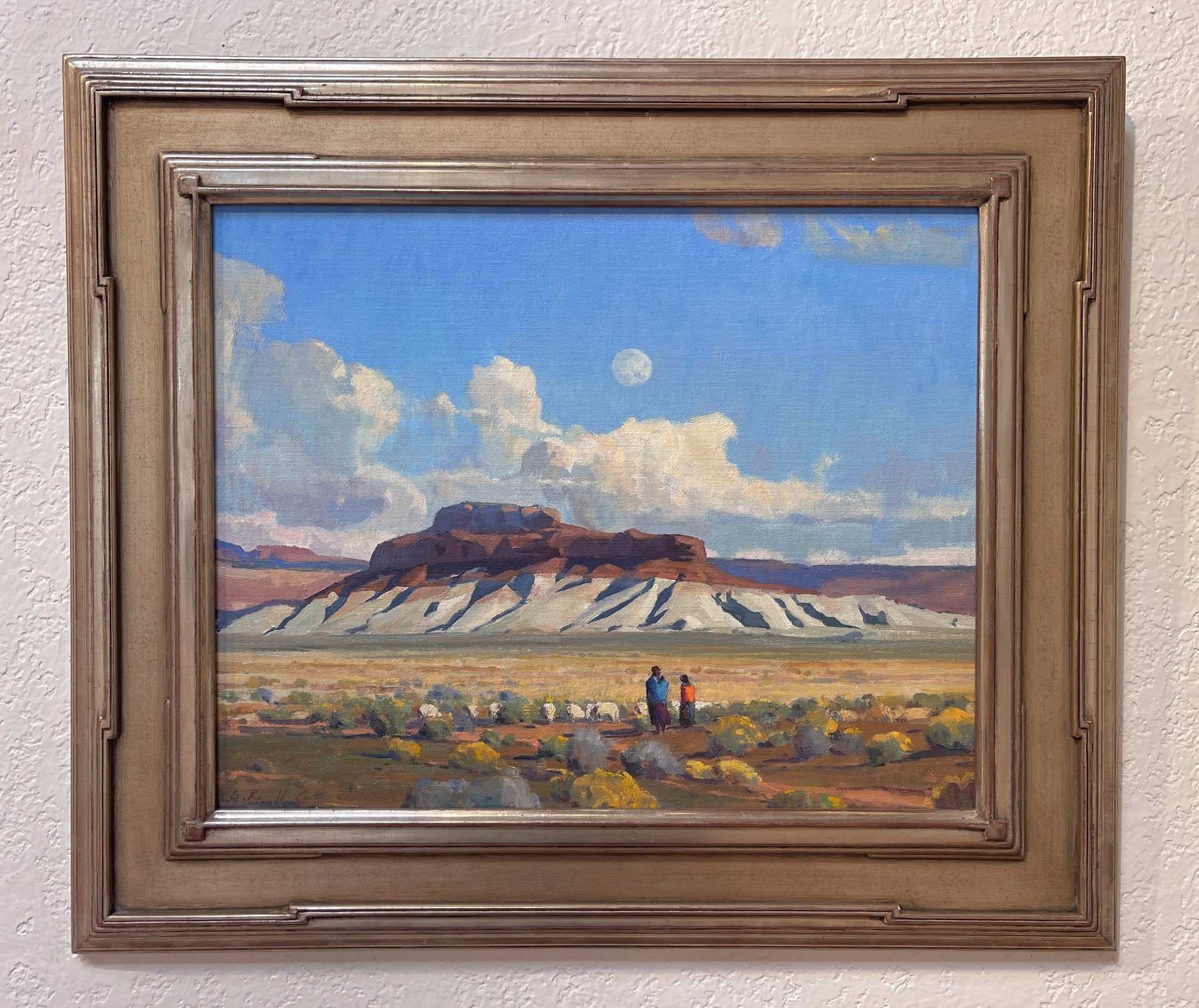 A painting of two people walking in the desert with a full moon in the sky.