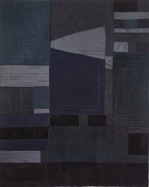 a black and blue quilt on a white background