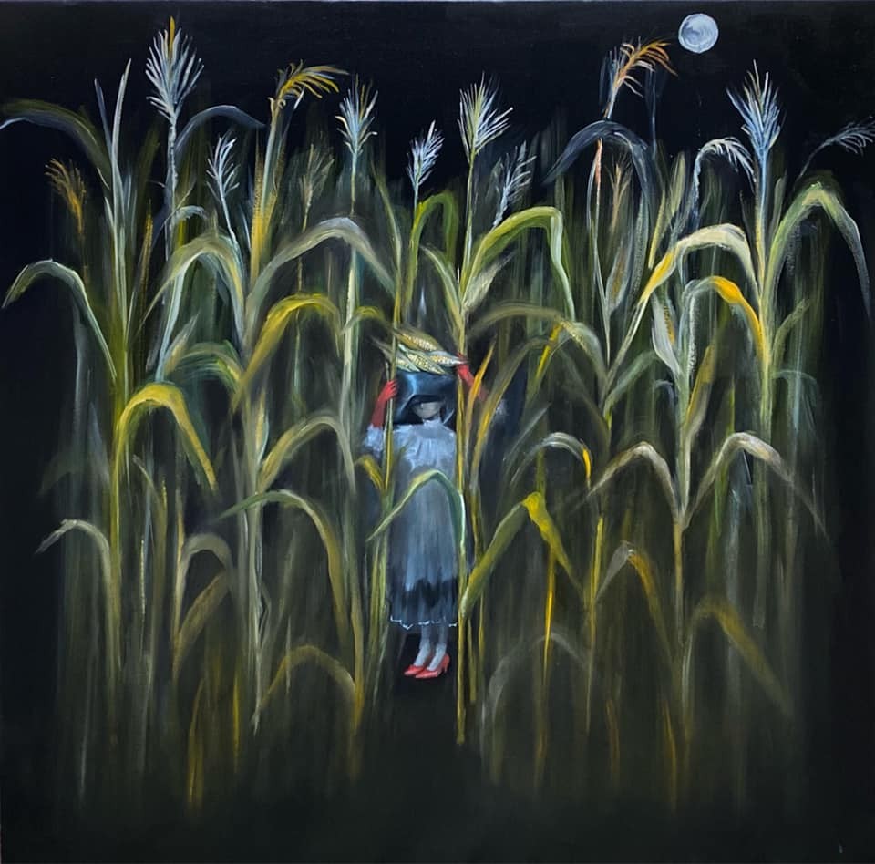 A mysterious figure stands hidden within a tall field of corn under a dark night sky.
