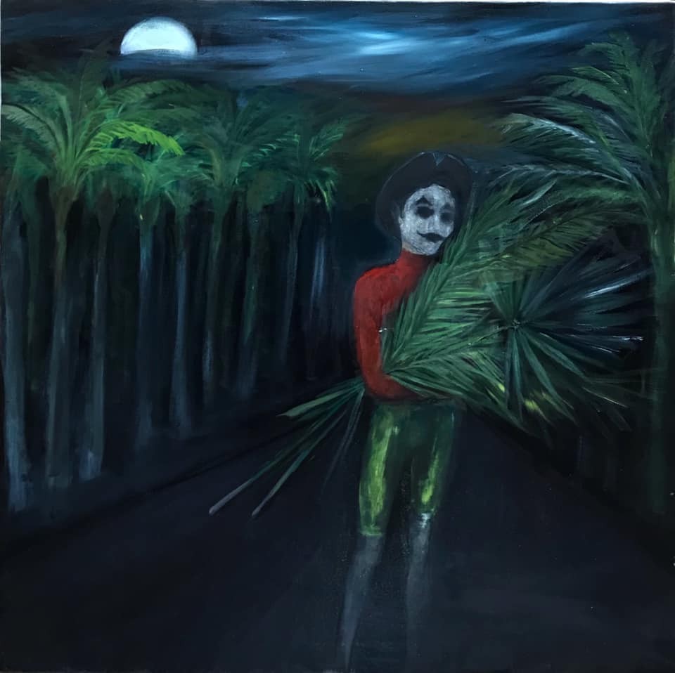 A masked figure in a red turtleneck carries palm fronds through a moonlit tropical forest.