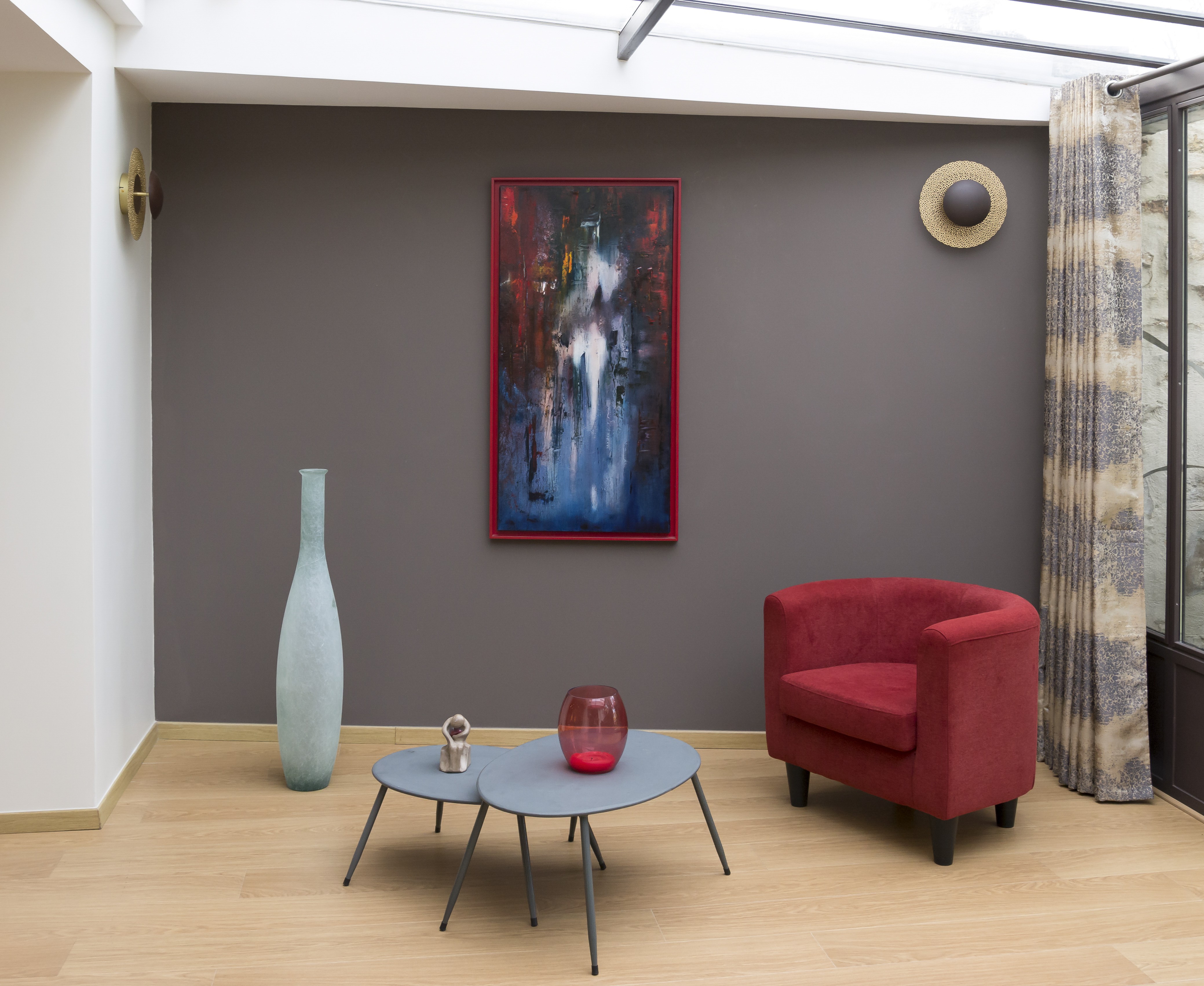 A vertical abstract painting featuring a central white figure emerging from a textured background of deep reds, blues, and blacks.