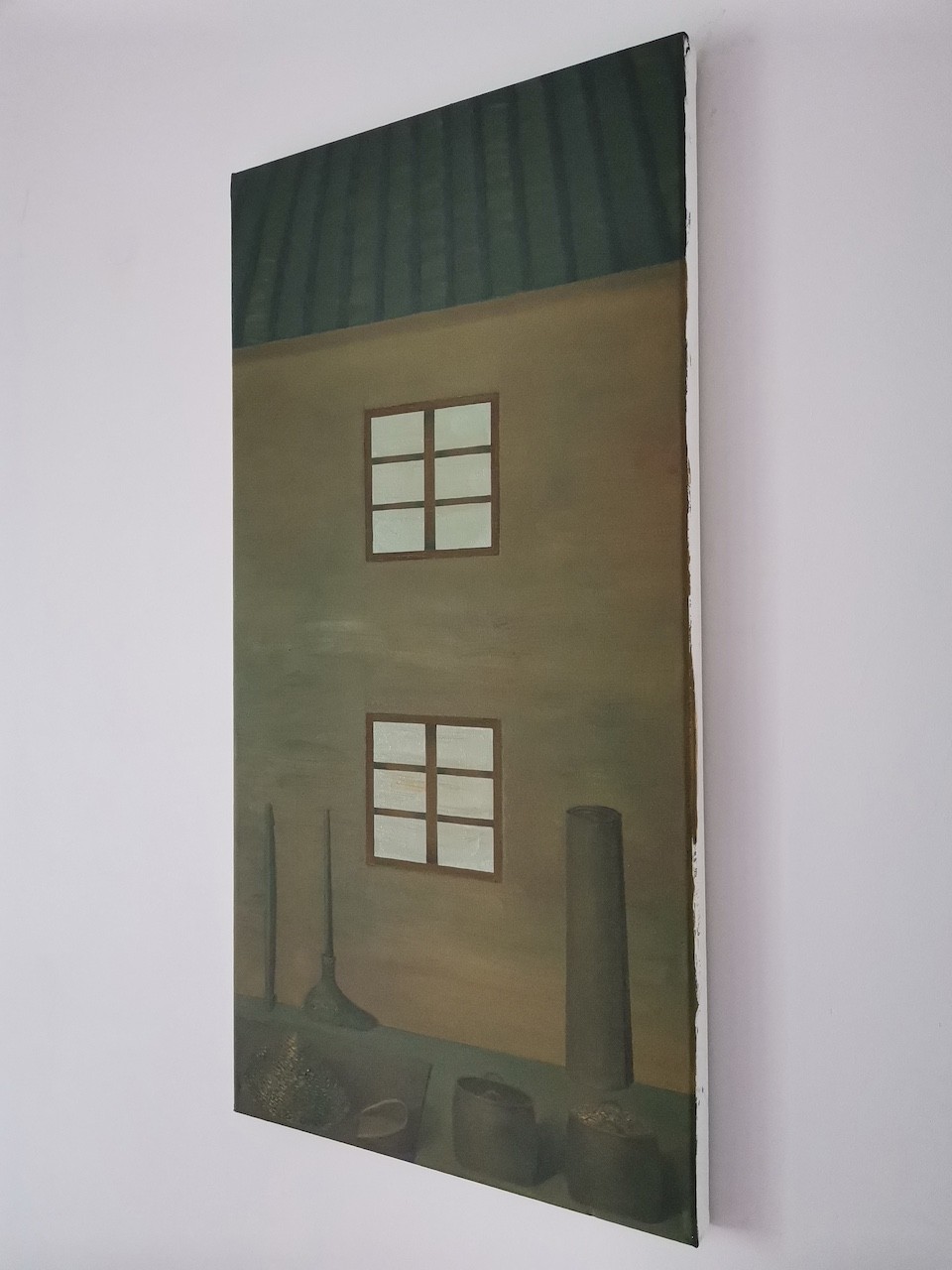 A quiet still life featuring household tools and a building facade with two windows.