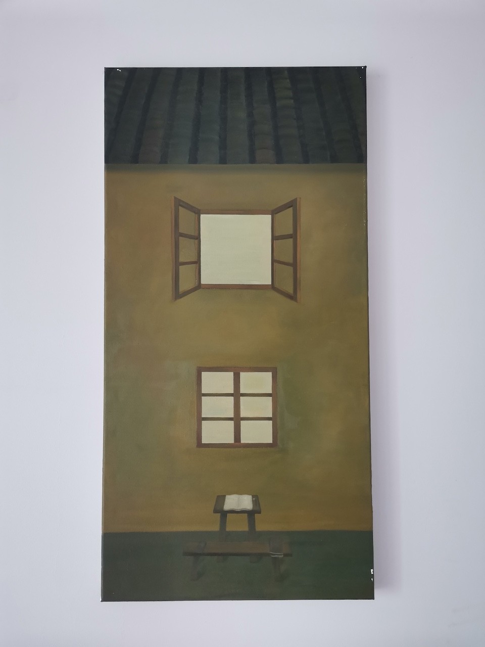 A quiet interior scene featuring a small table with an open book, set against a wall with two windows.