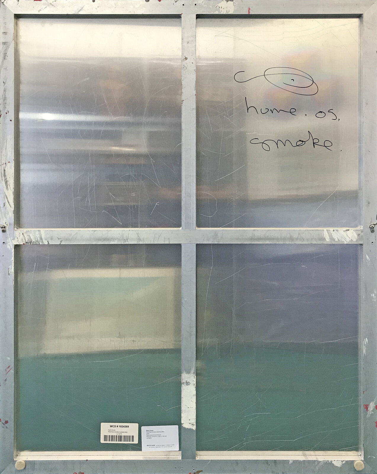 A red and silver painting of a woman's face on a metal surface.