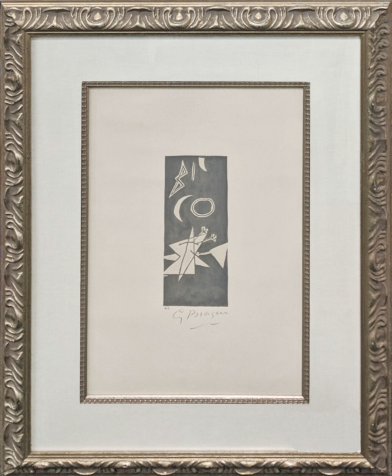 A picture of a black and white drawing in a gold frame.