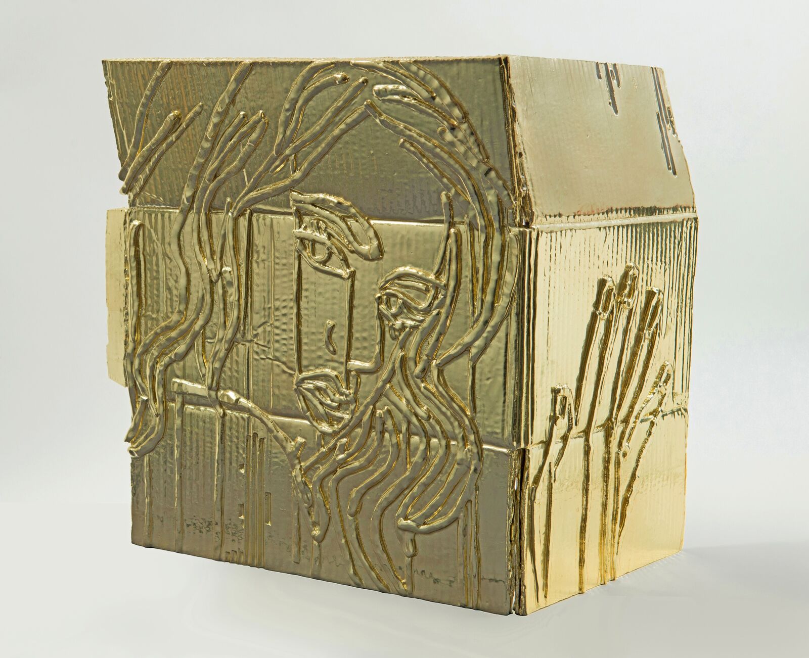 A gold box with a face on it. 