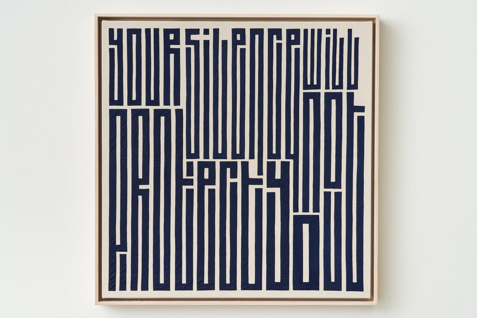 A blue and white poster hanging on a wall.