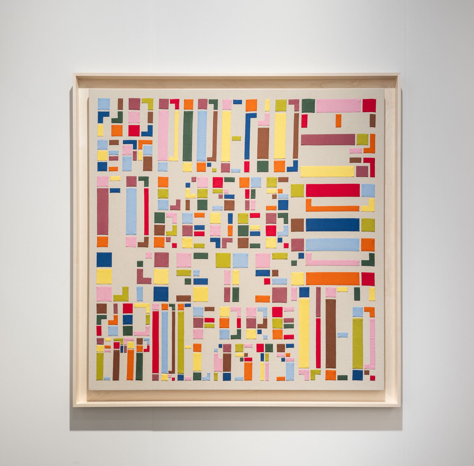 A colorful geometric composition featuring a grid of rectangular shapes in various hues.