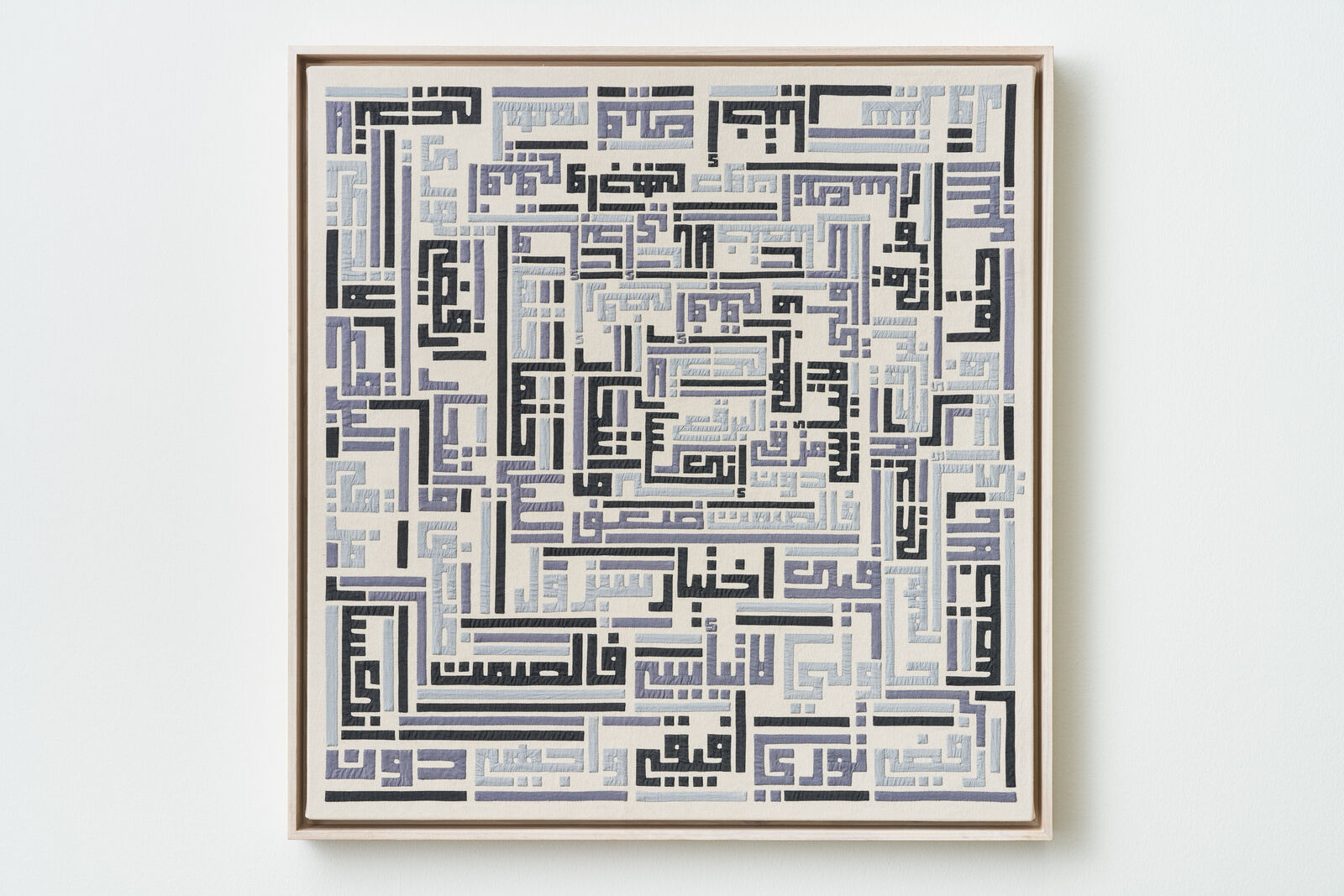 A blue and white abstract painting on a white wall.