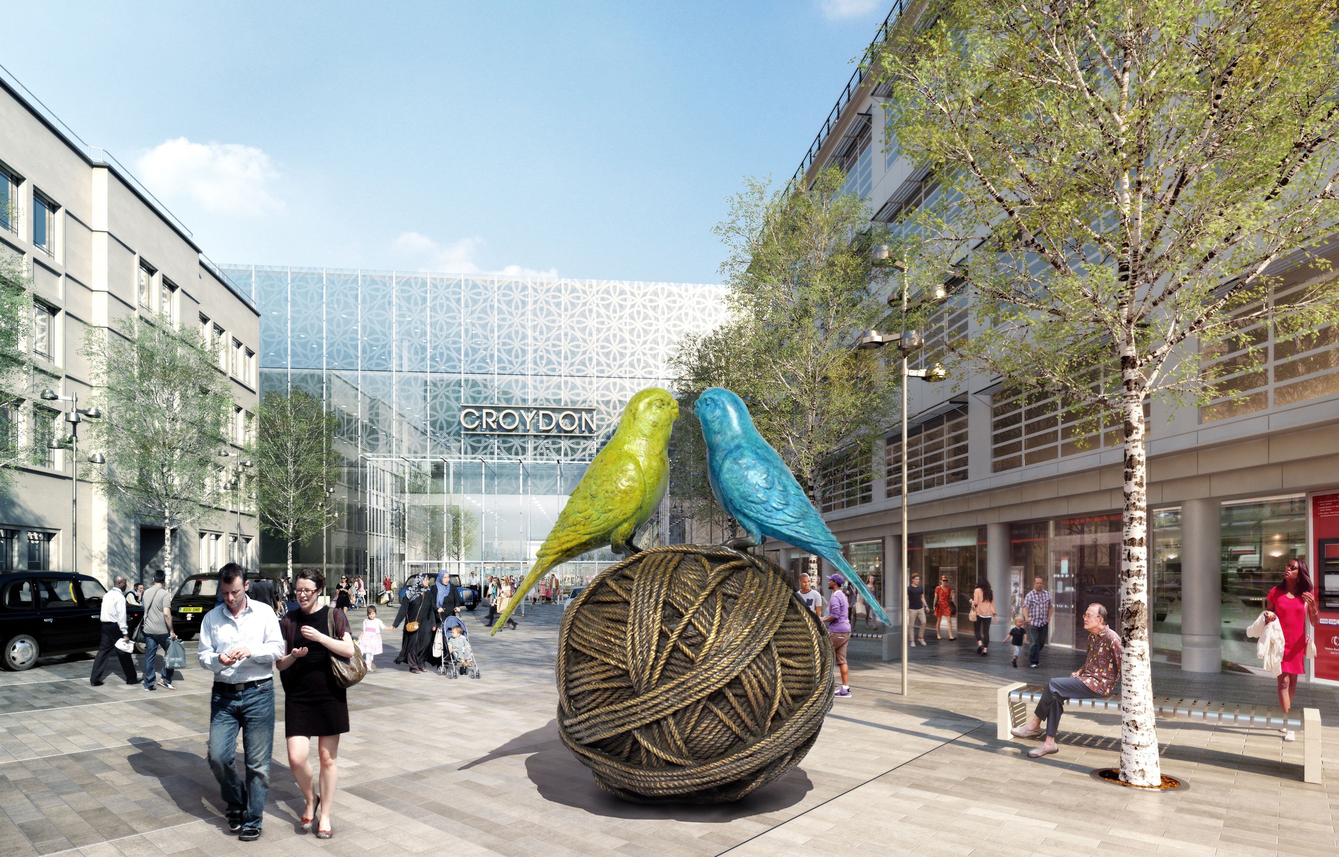 A couple of birds sitting on top of a ball of yarn.