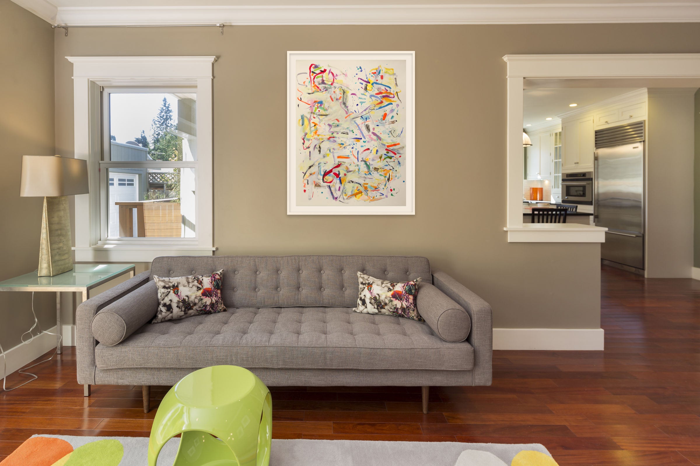 A large abstract painting on a white wall.