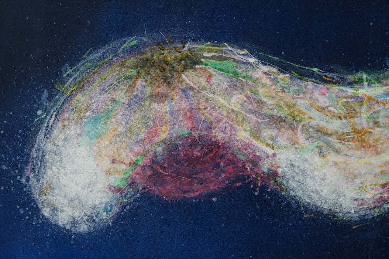 A textured abstract composition featuring a central organic form against a deep blue background.