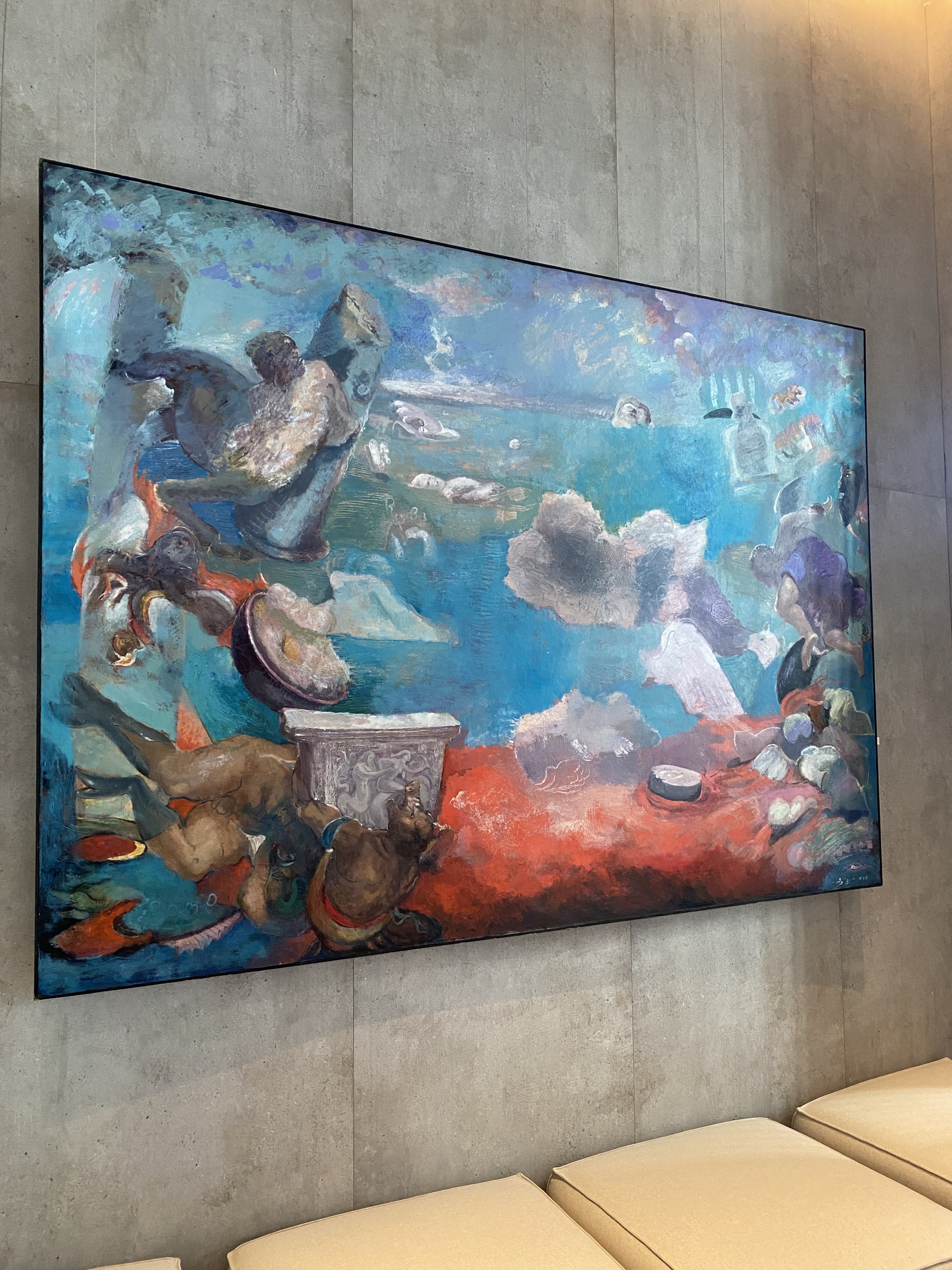 A large painting hanging on the wall in a room.