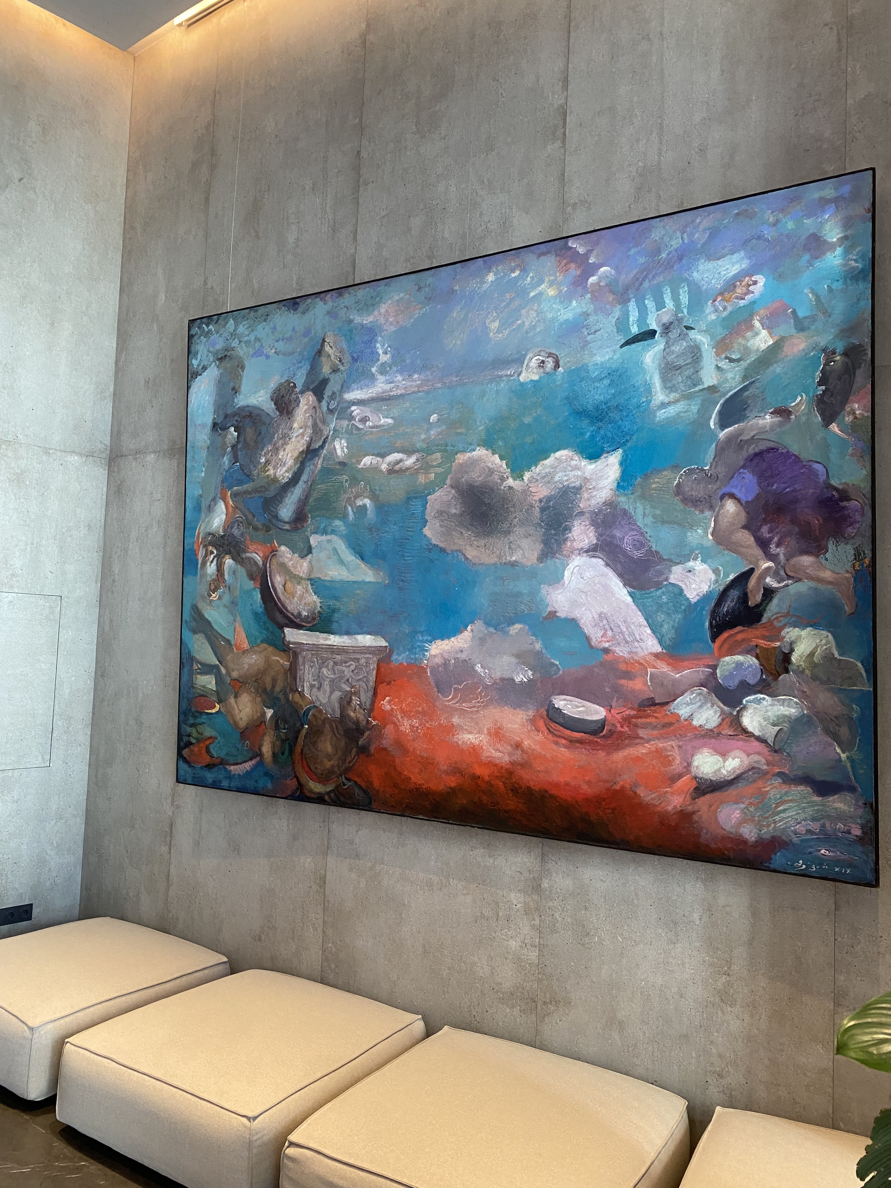 A large painting hanging on the wall in a room.