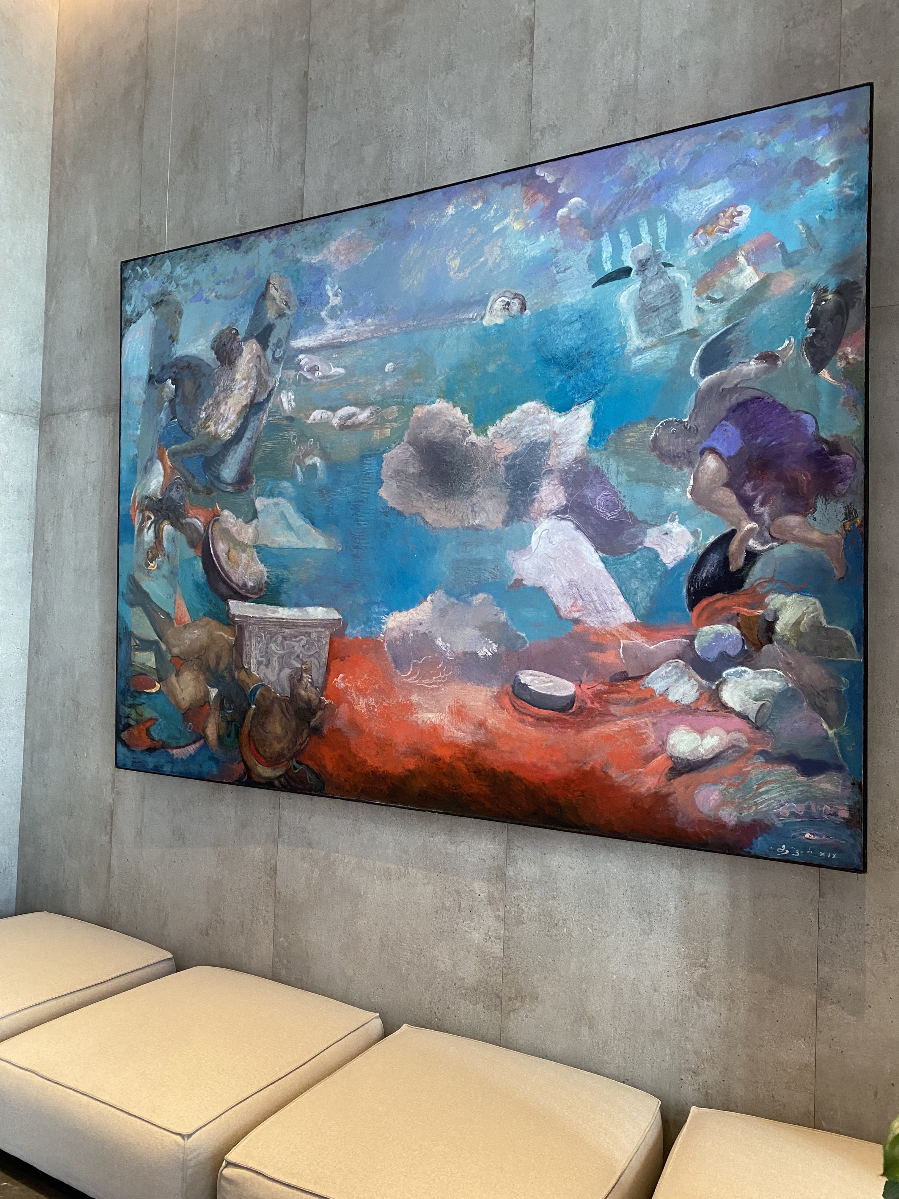 A large painting hanging on the wall in a room.