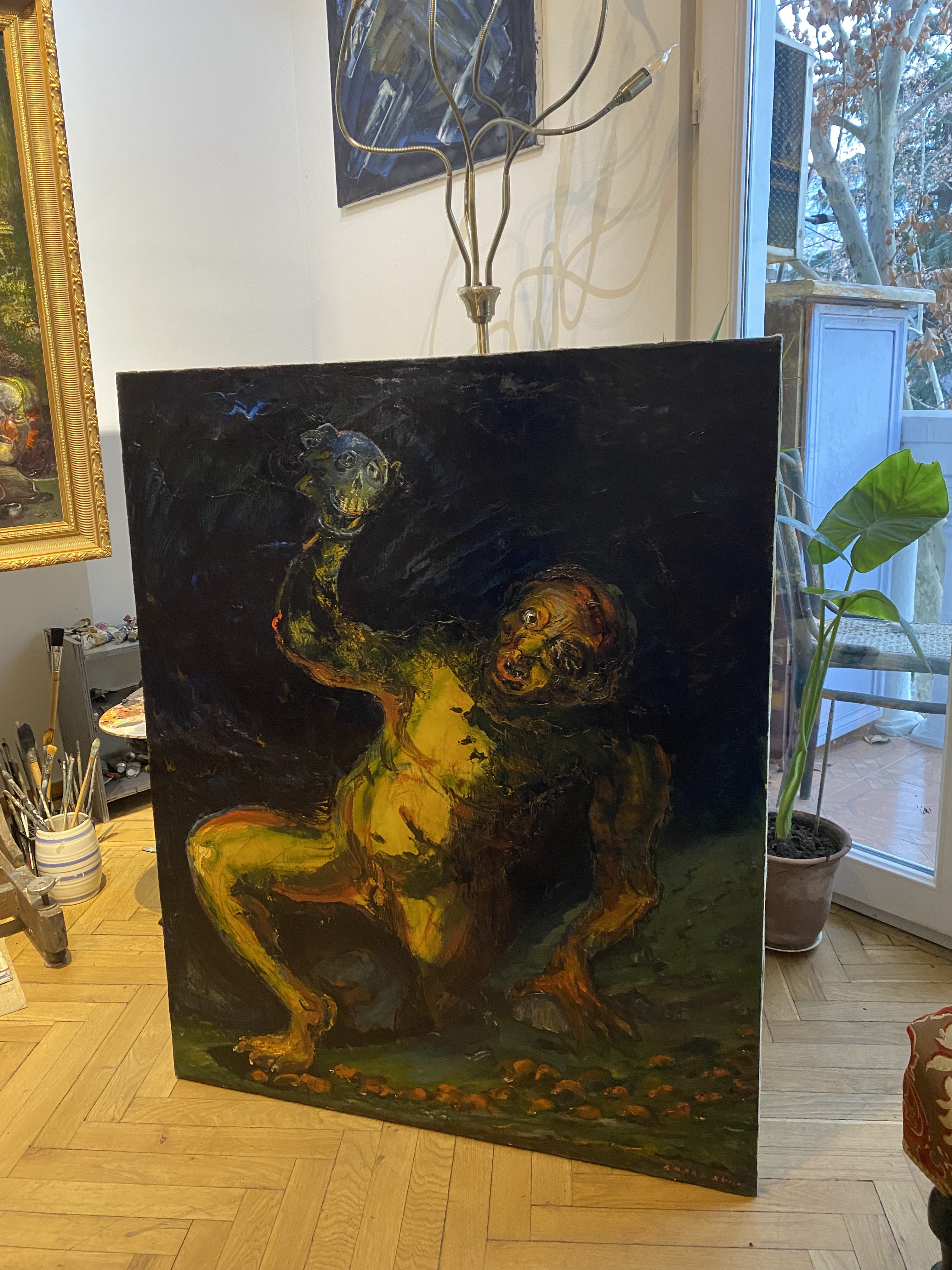 A painting of a man holding a skull in his hand.