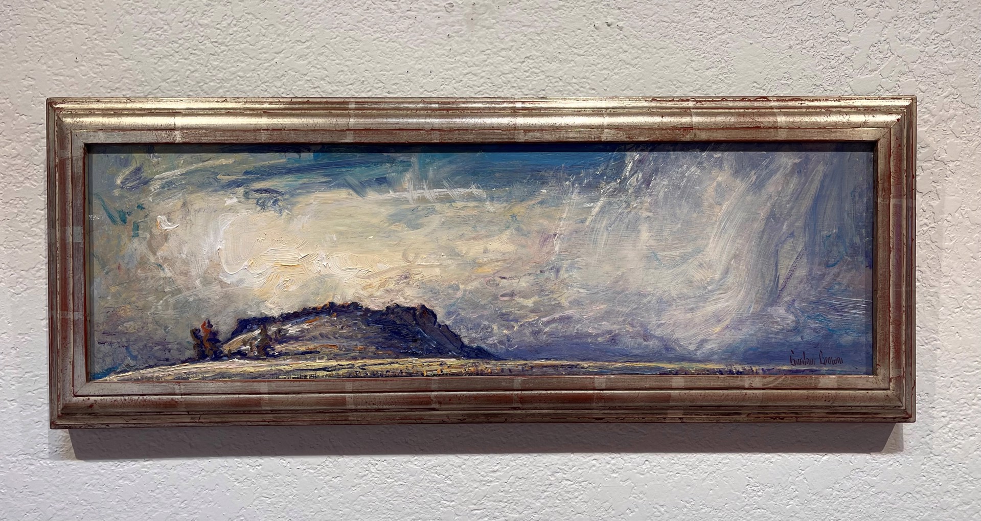 A painting of a cloudy sky over a mountain.