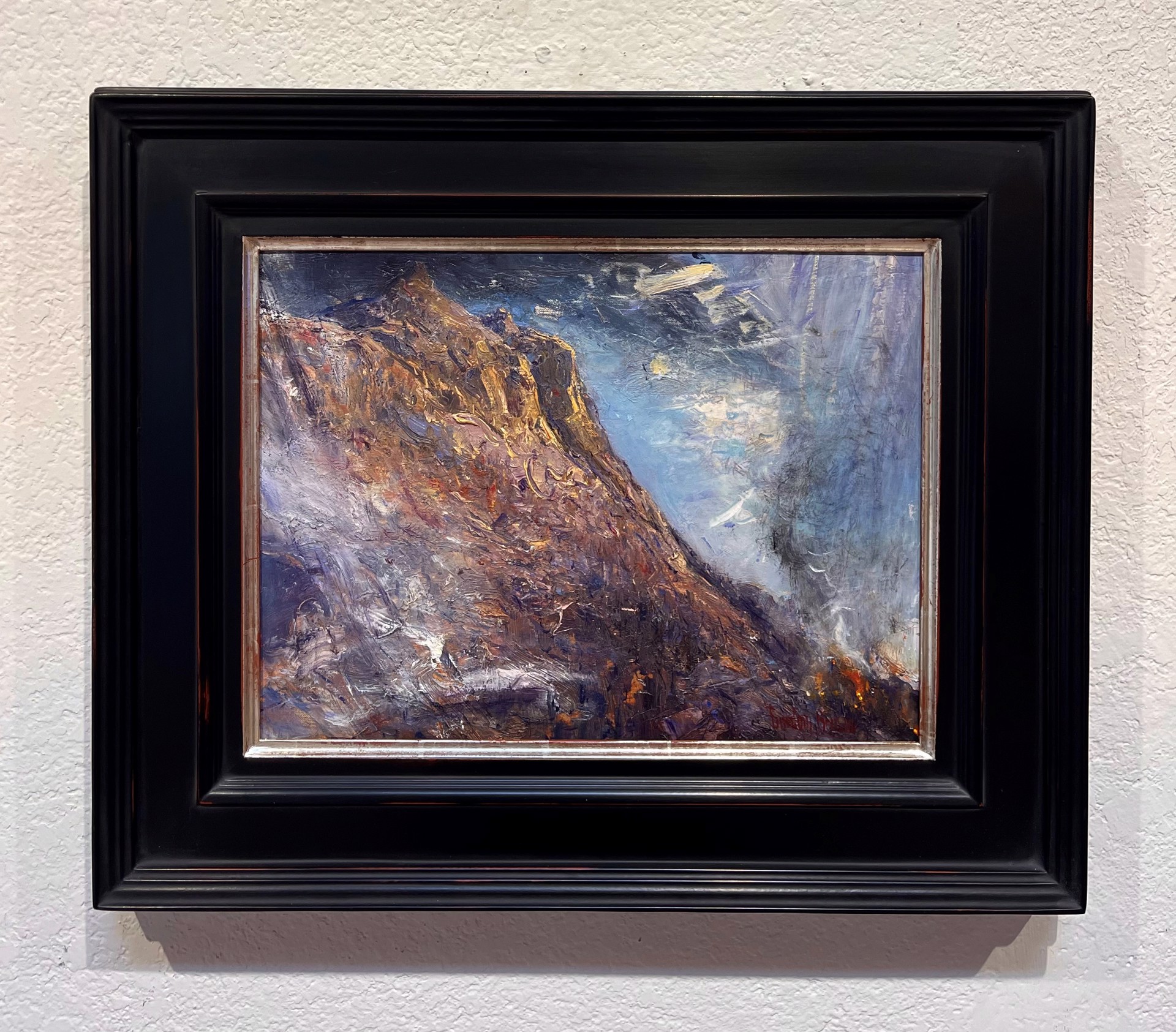 A painting of a mountain with a cloudy sky.