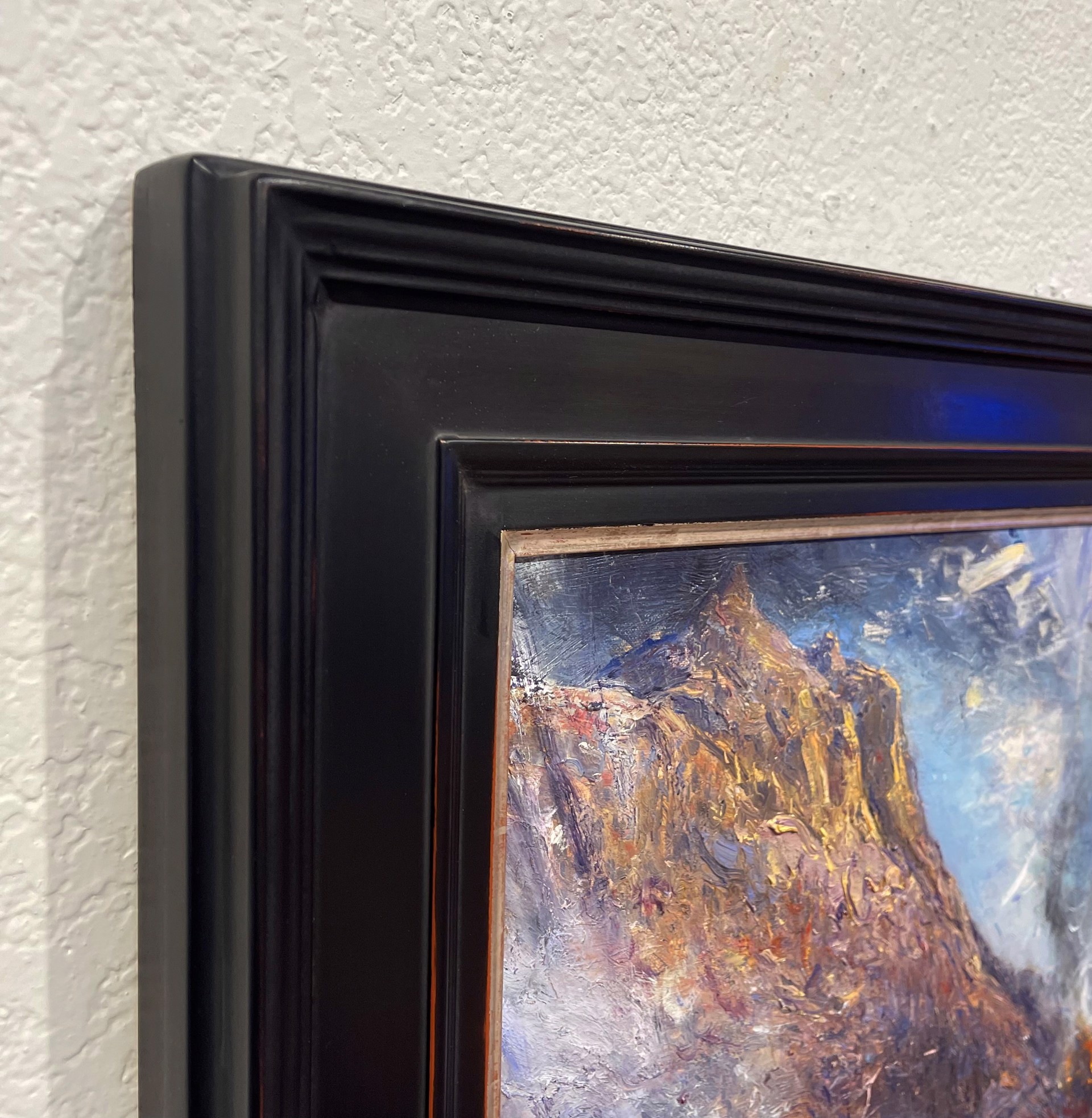 A painting of a mountain with a cloudy sky.