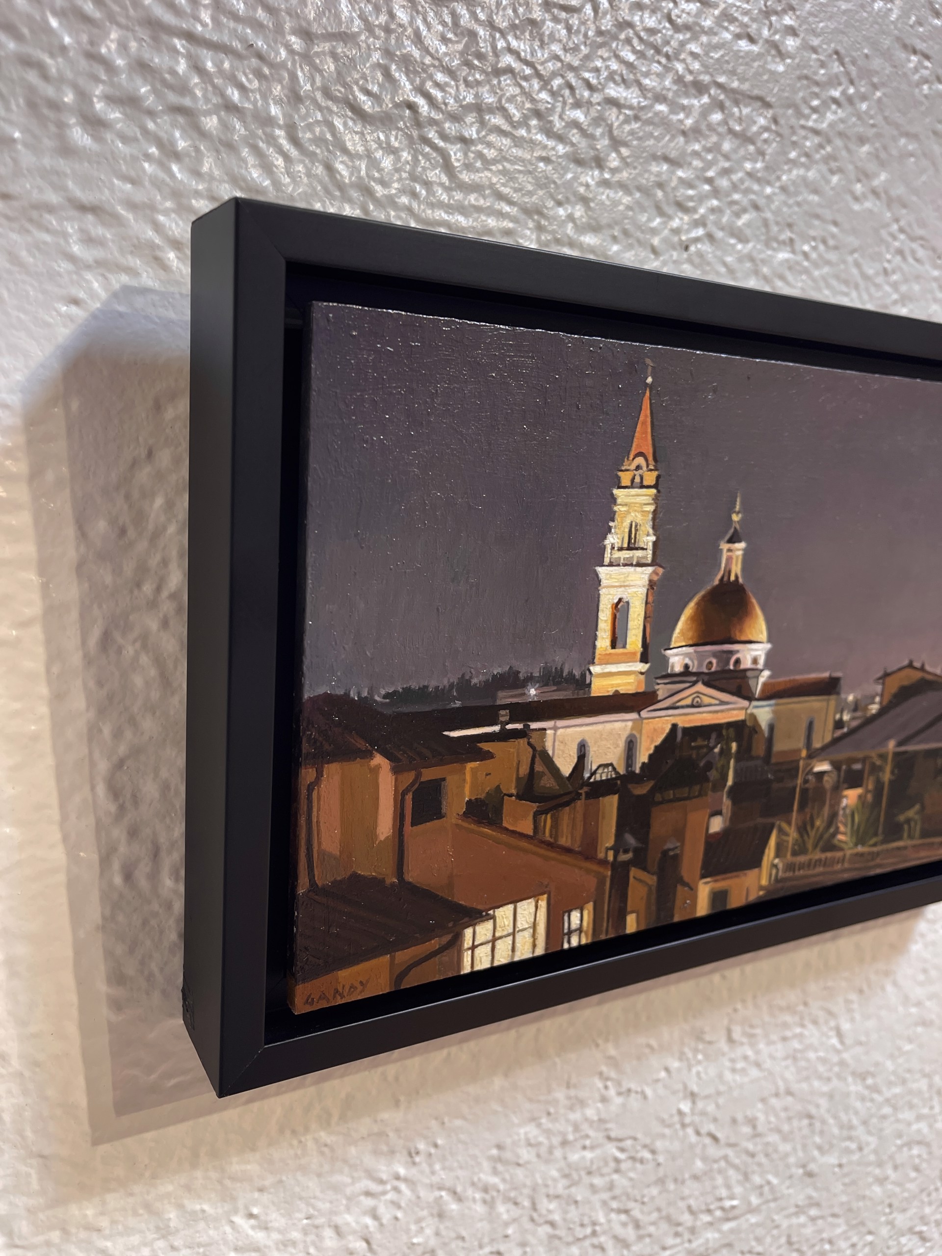 A painting of a city at night with a church in the background.