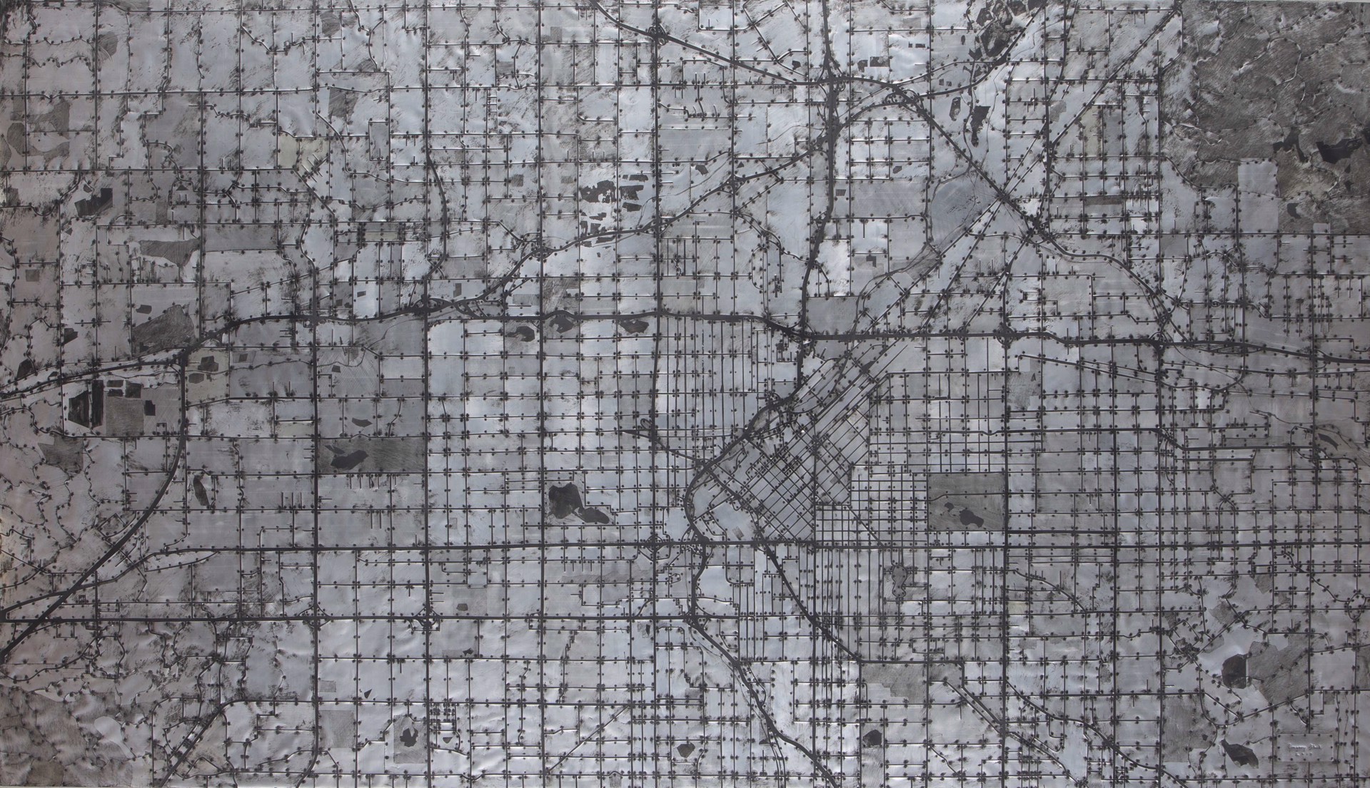 A black and white map of a city on a wall.