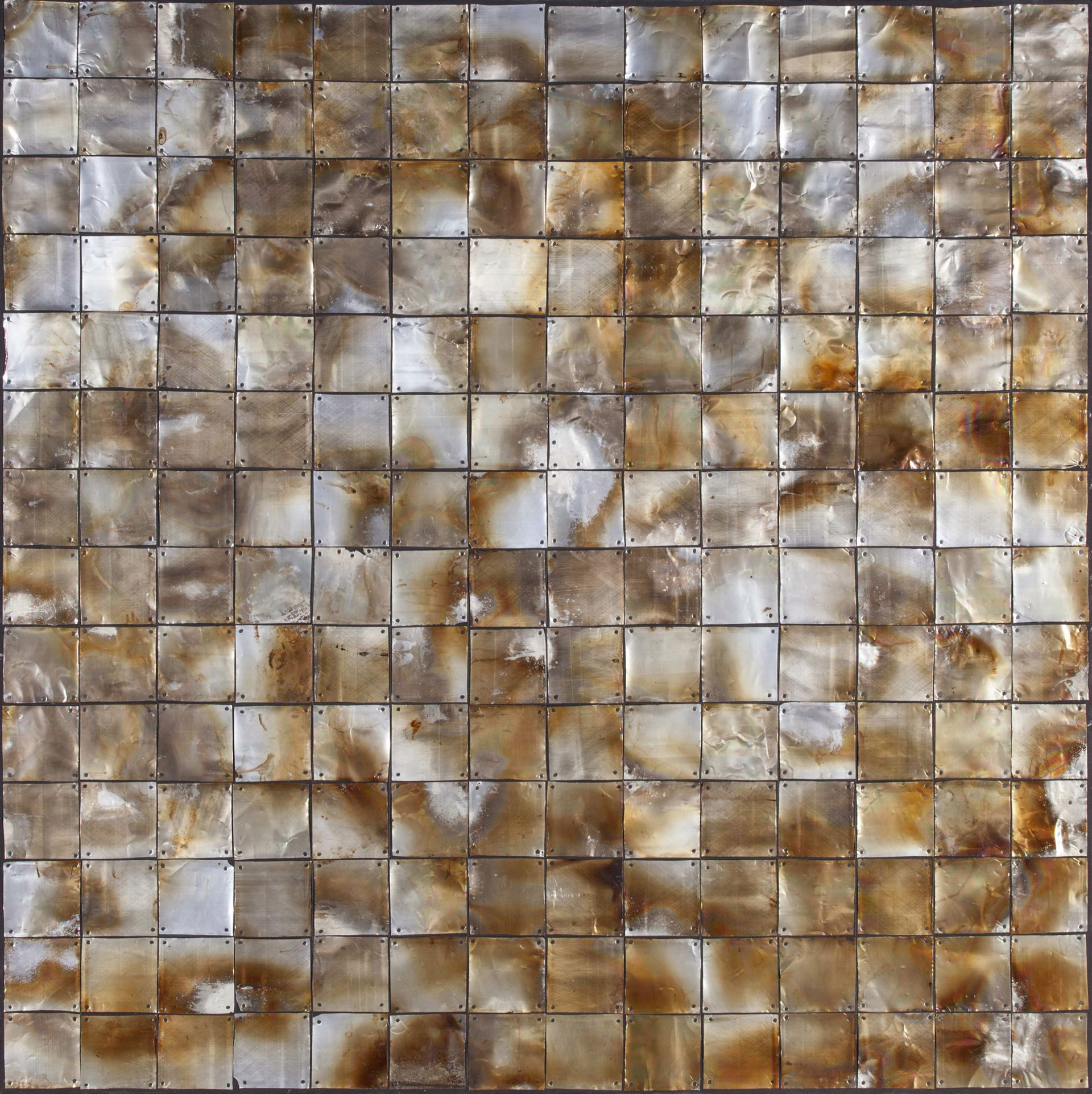 a close up of a metal wall with a pattern on it