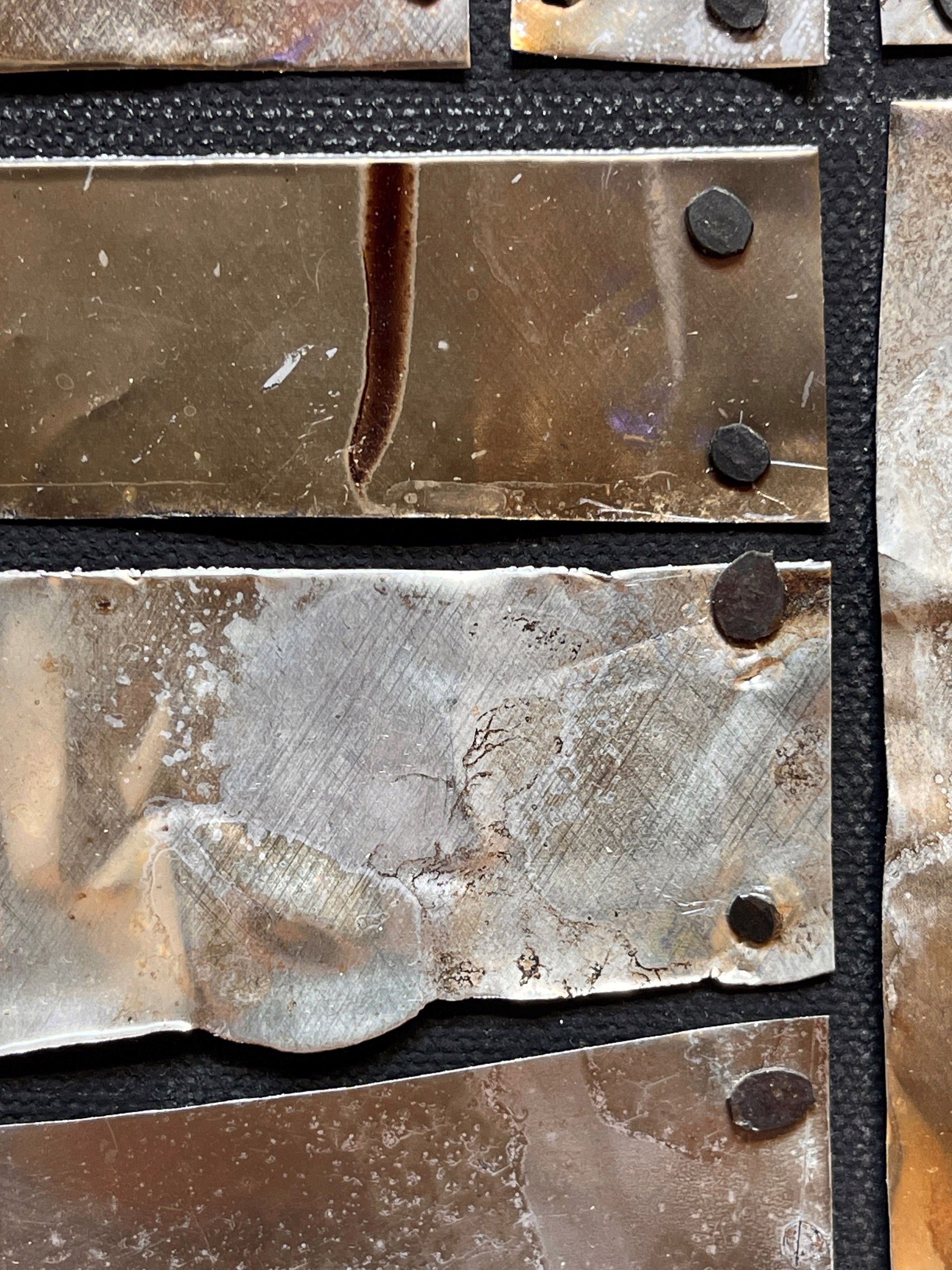 a close up of a metal wall with a pattern on it