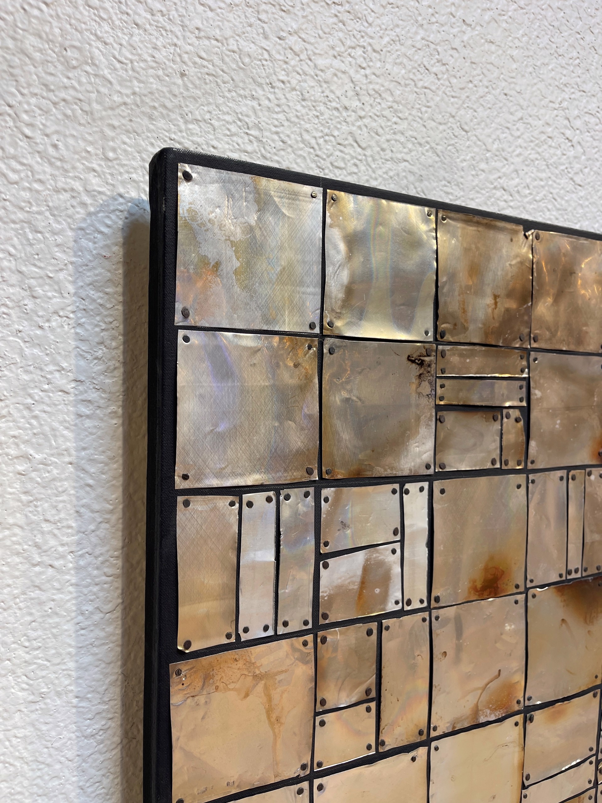 a close up of a metal wall with a pattern on it