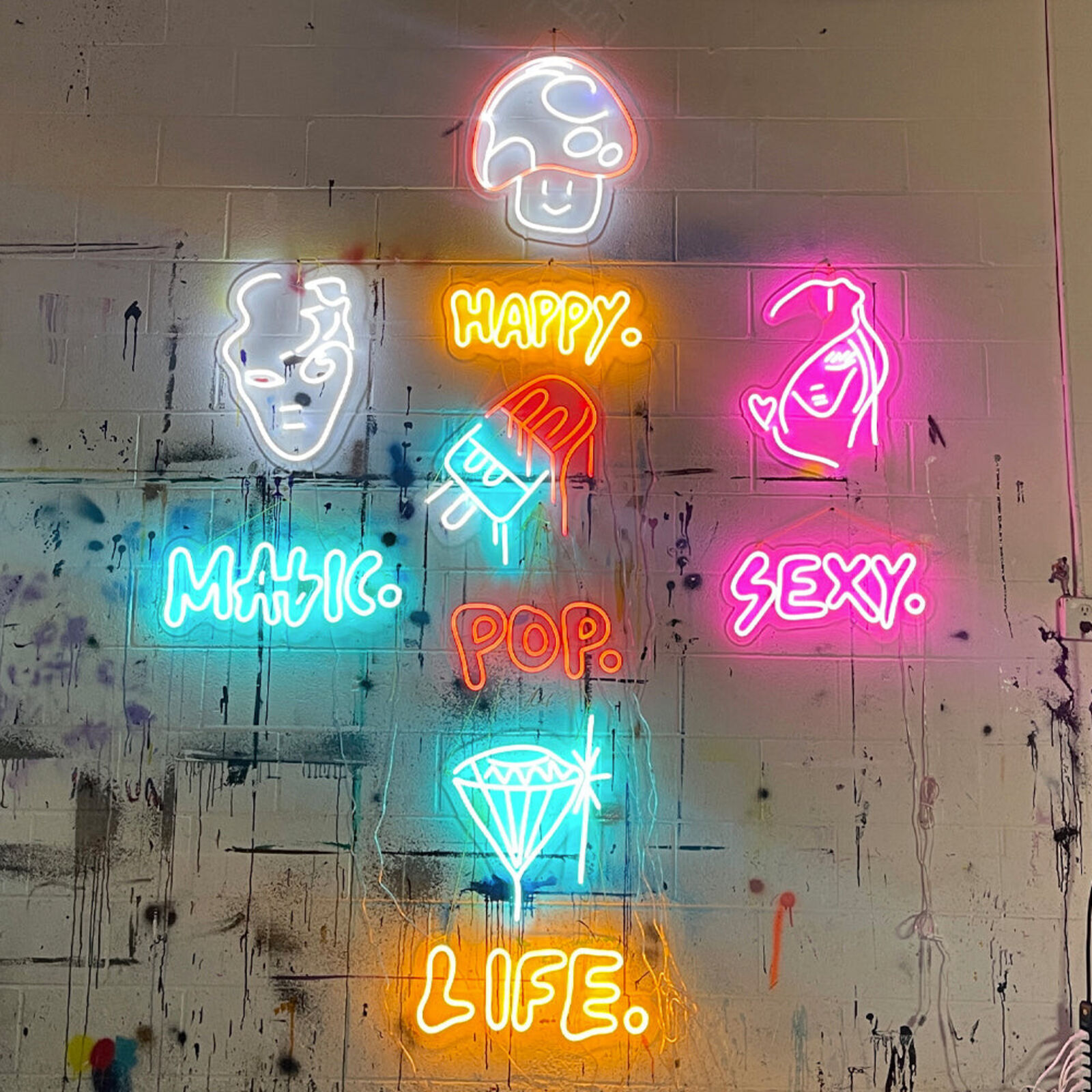 A neon sign that says happy, magic, pop, sexy, life.
