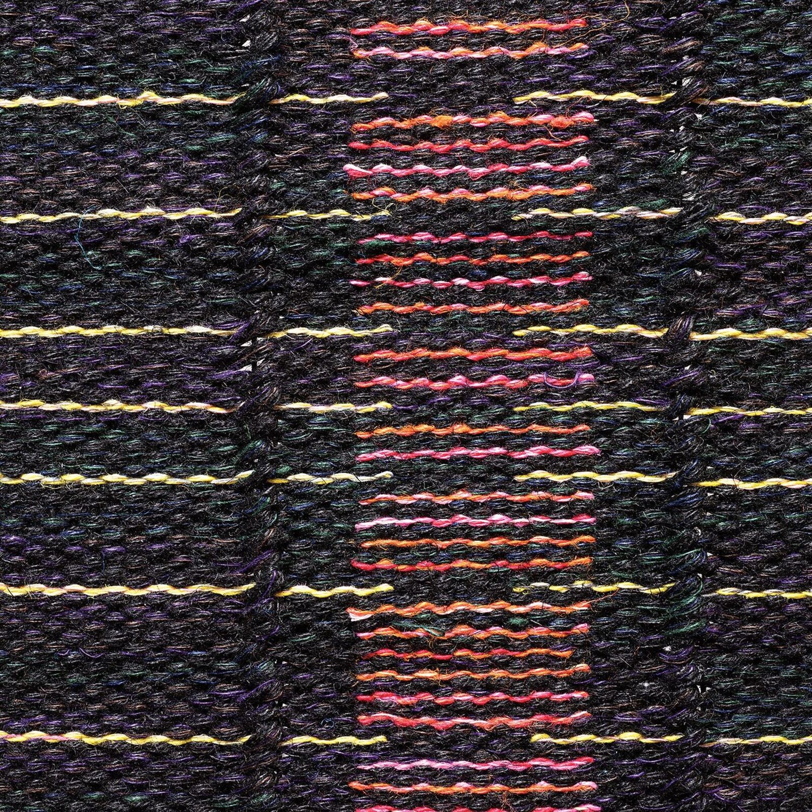 A woven textile featuring a central vertical motif of pink and red blocks against a dark background with horizontal yellow lines.