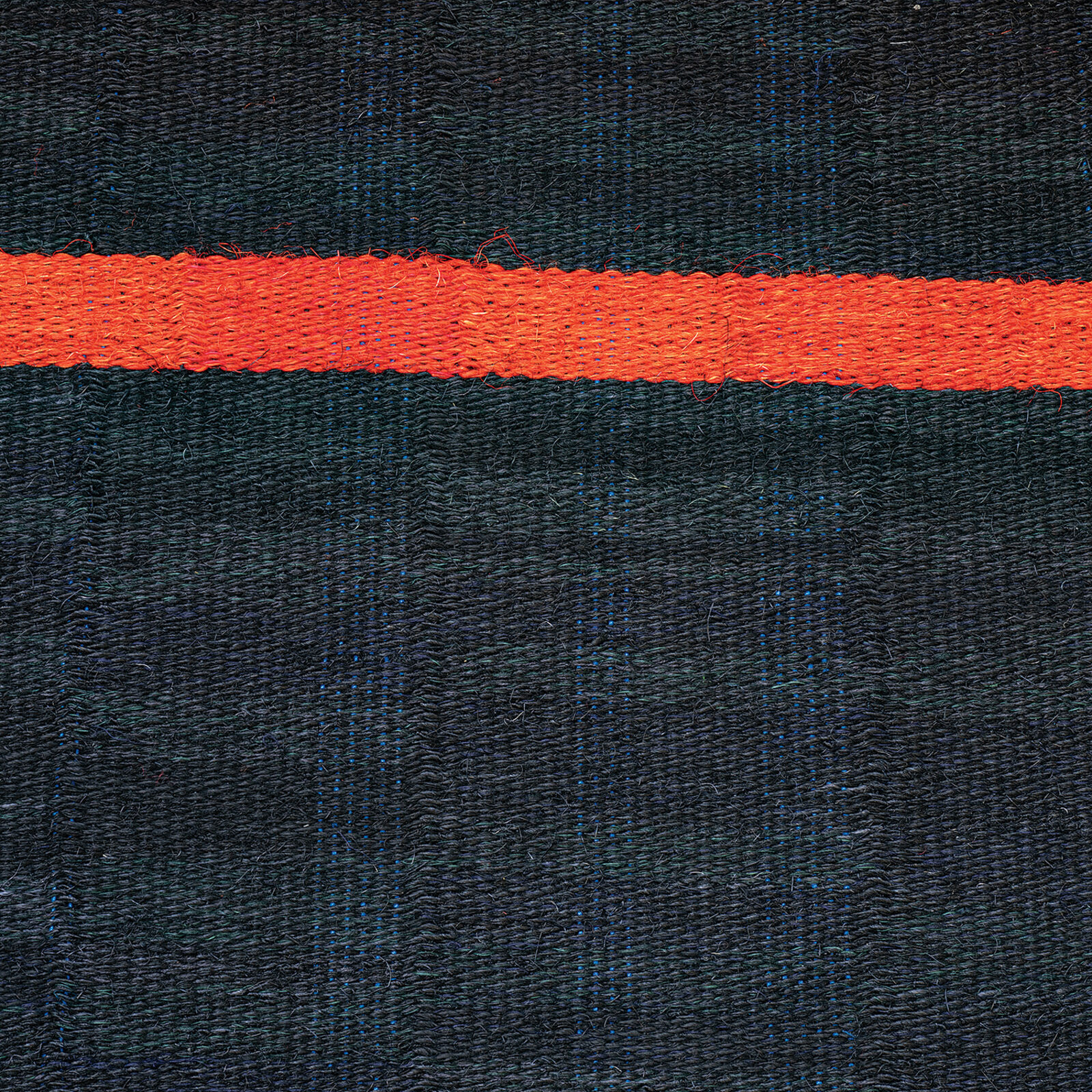 A piece of fabric with a red line on it.