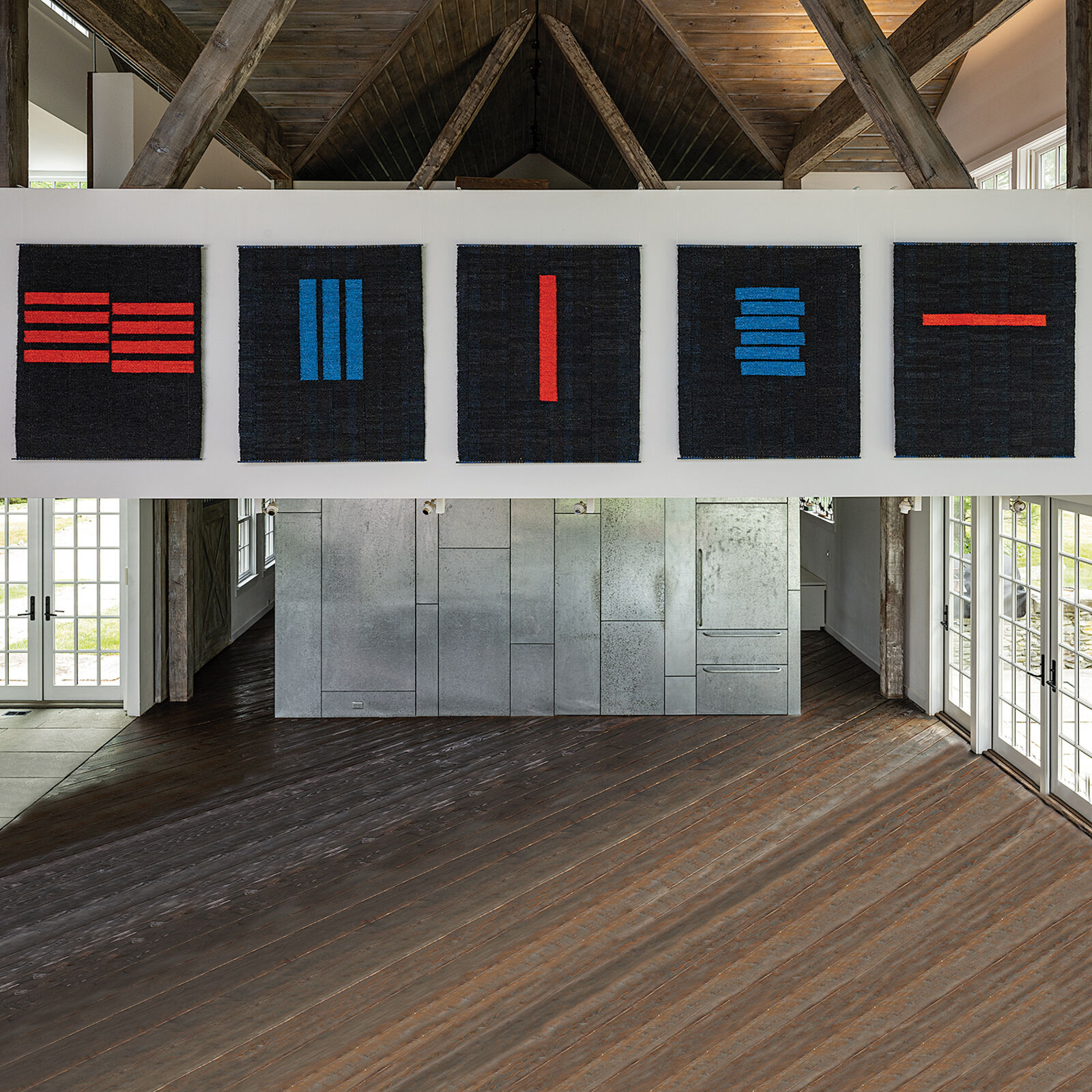 A woven textile featuring a bold red vertical stripe against a dark textured background.