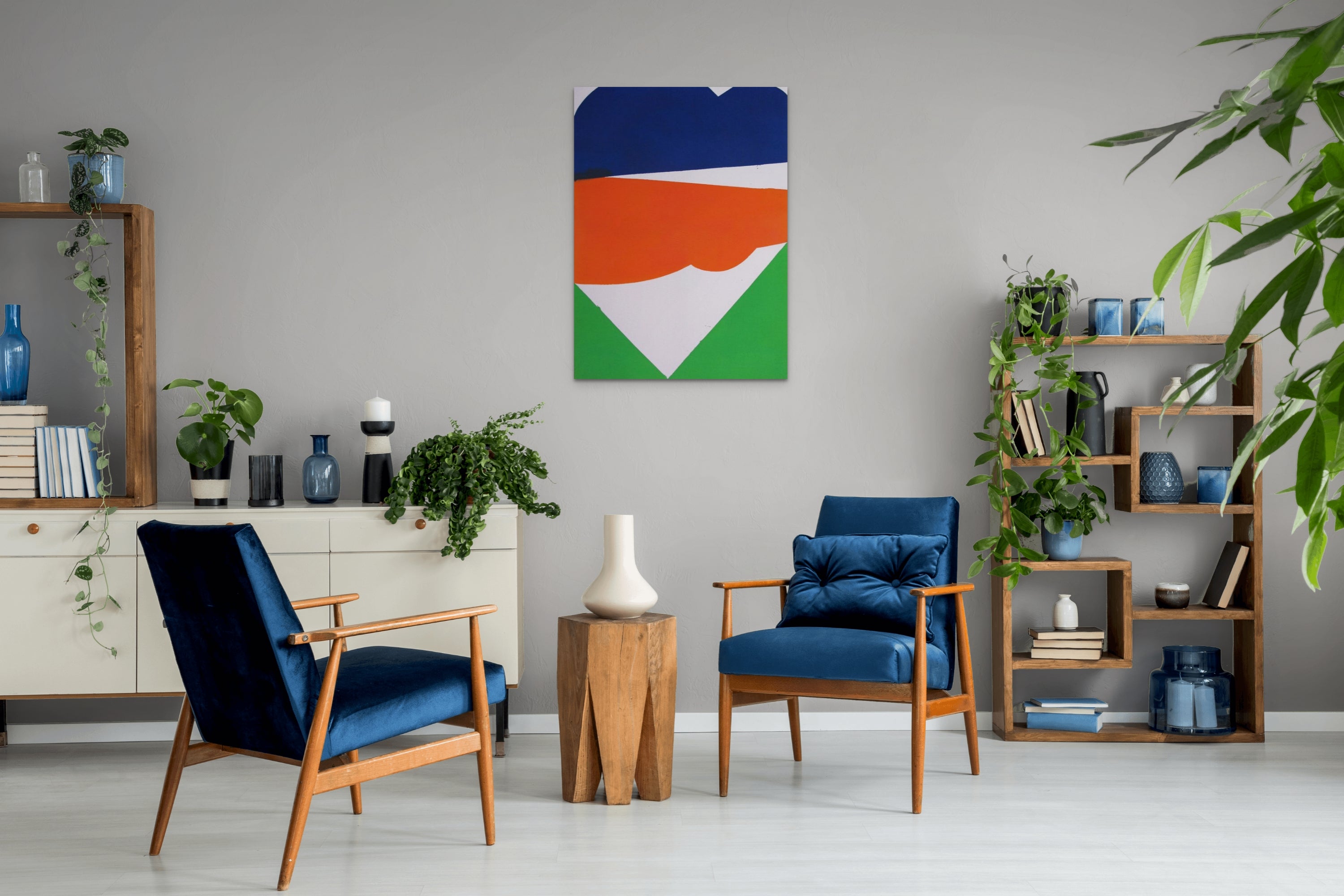 A blue, orange, green, and white painting on a white wall.