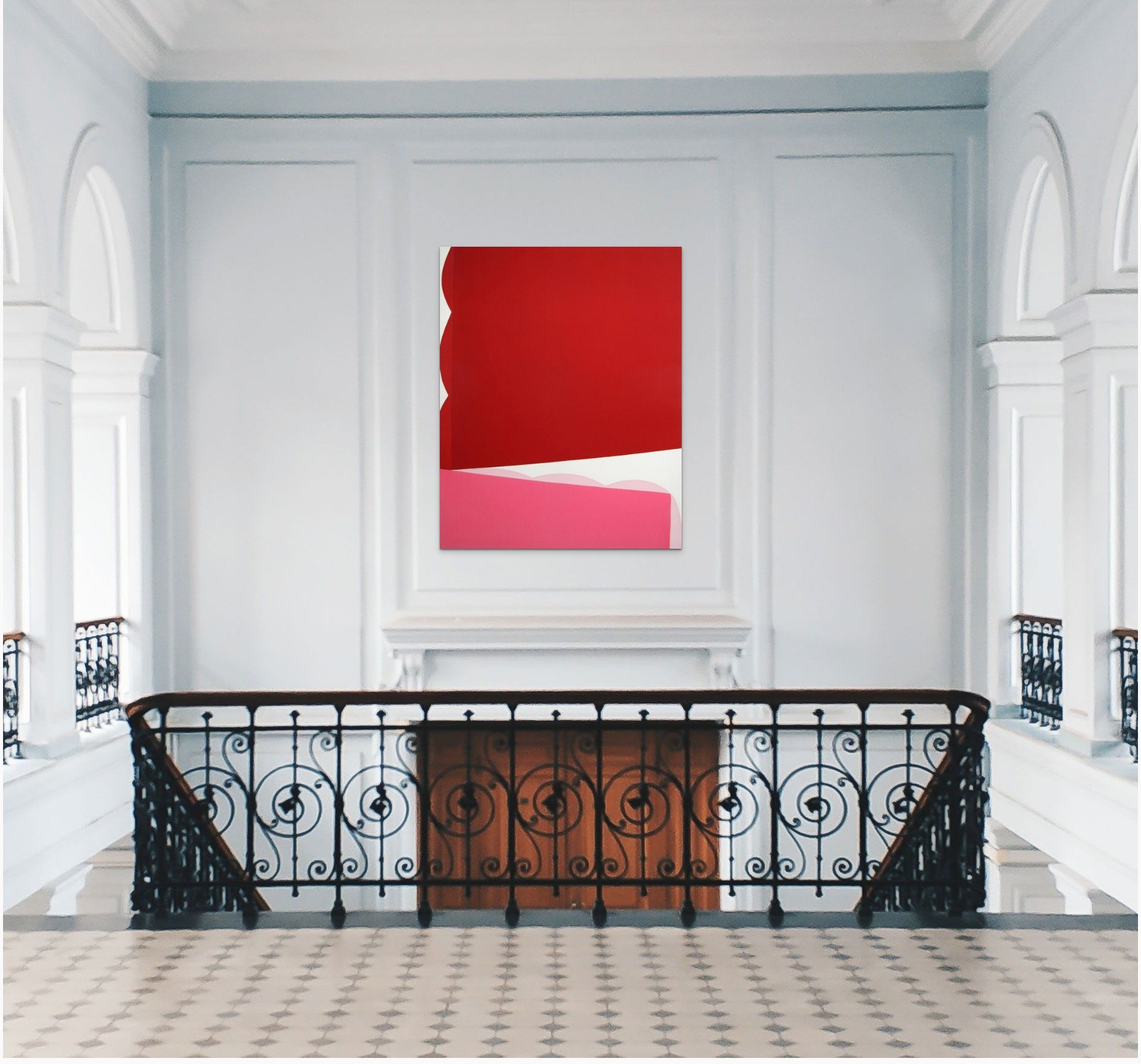 A red and pink painting on a white wall.