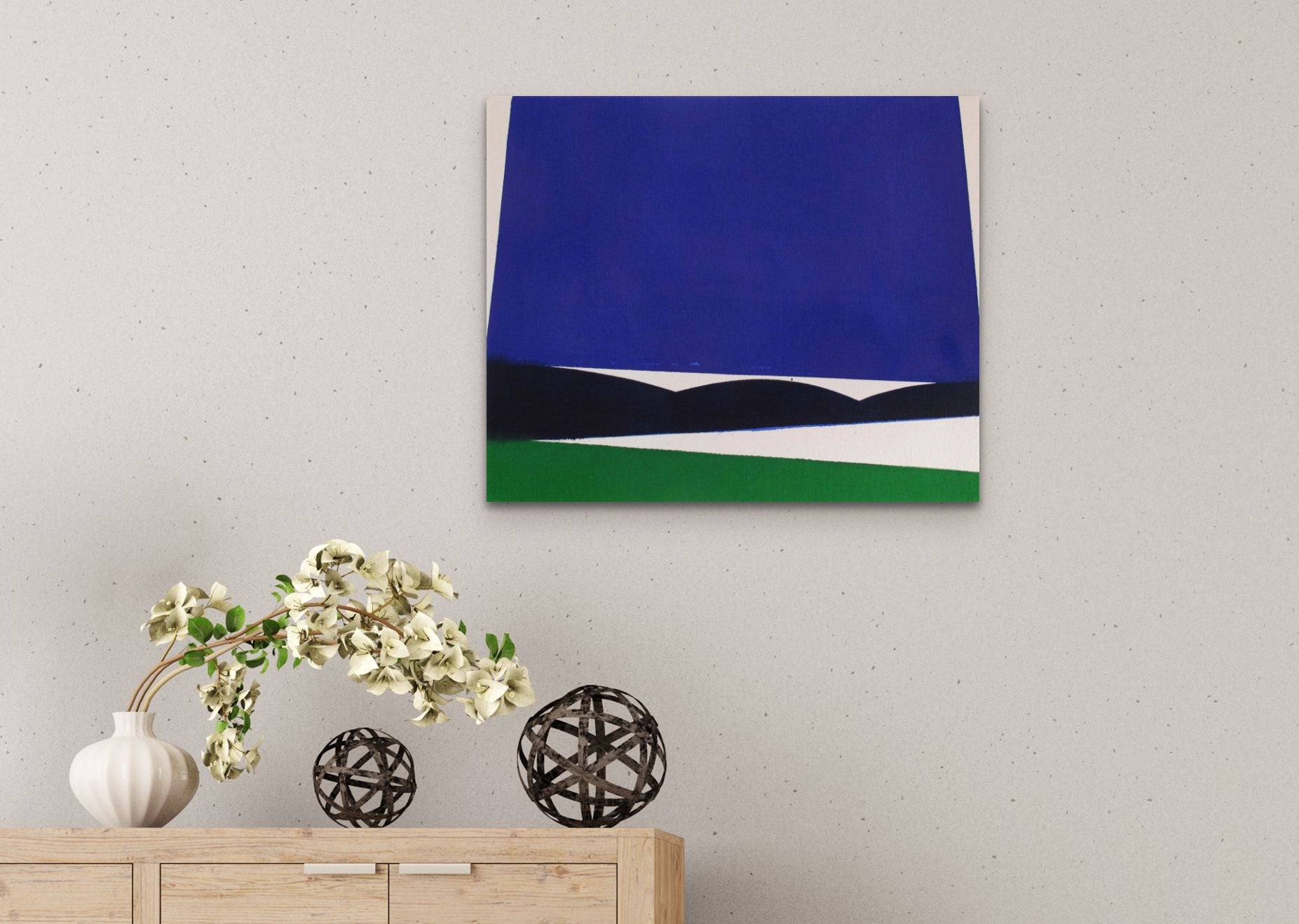 A blue and green painting on a white wall.