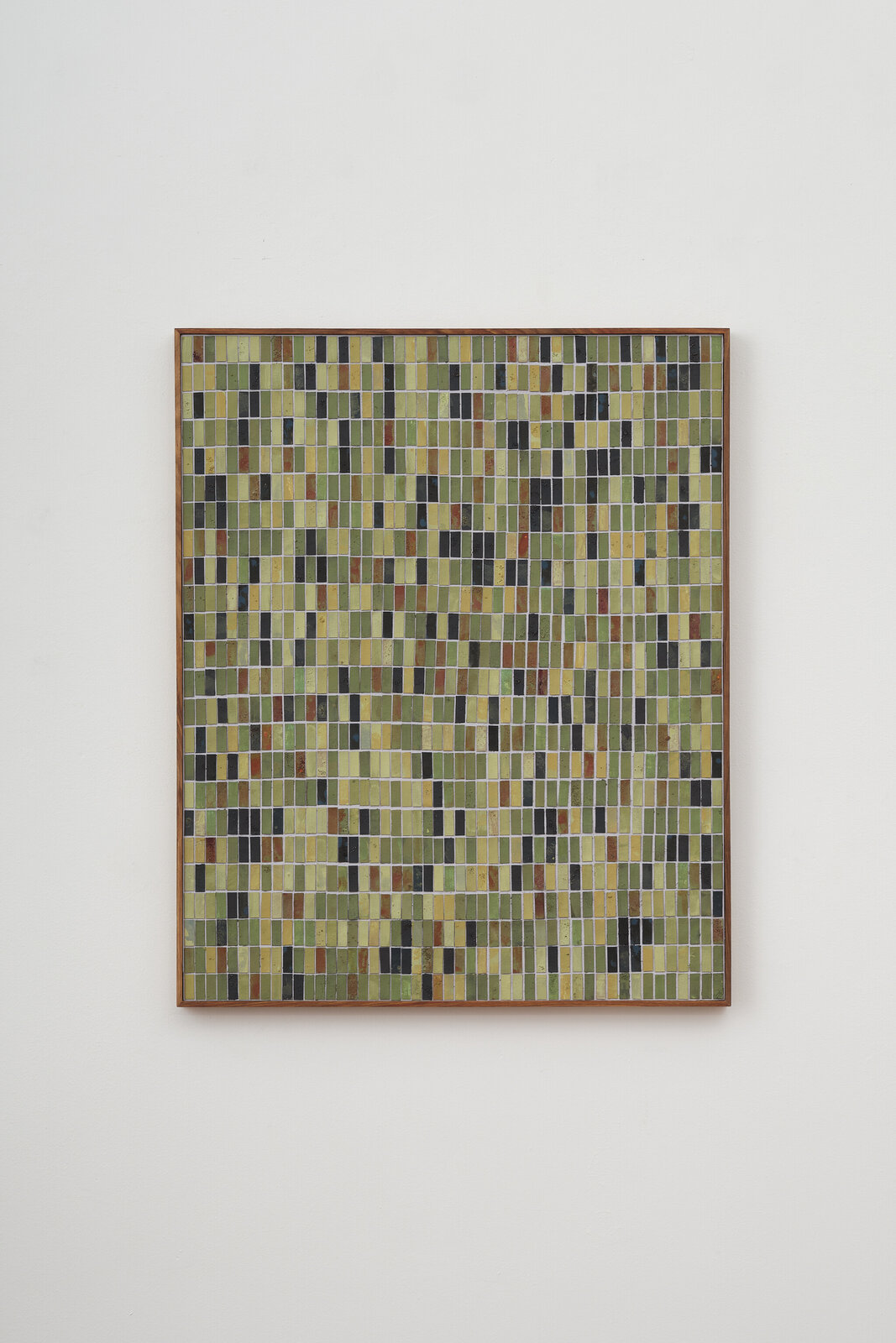 A framed mosaic artwork composed of vertical rectangular tiles in earthy tones.