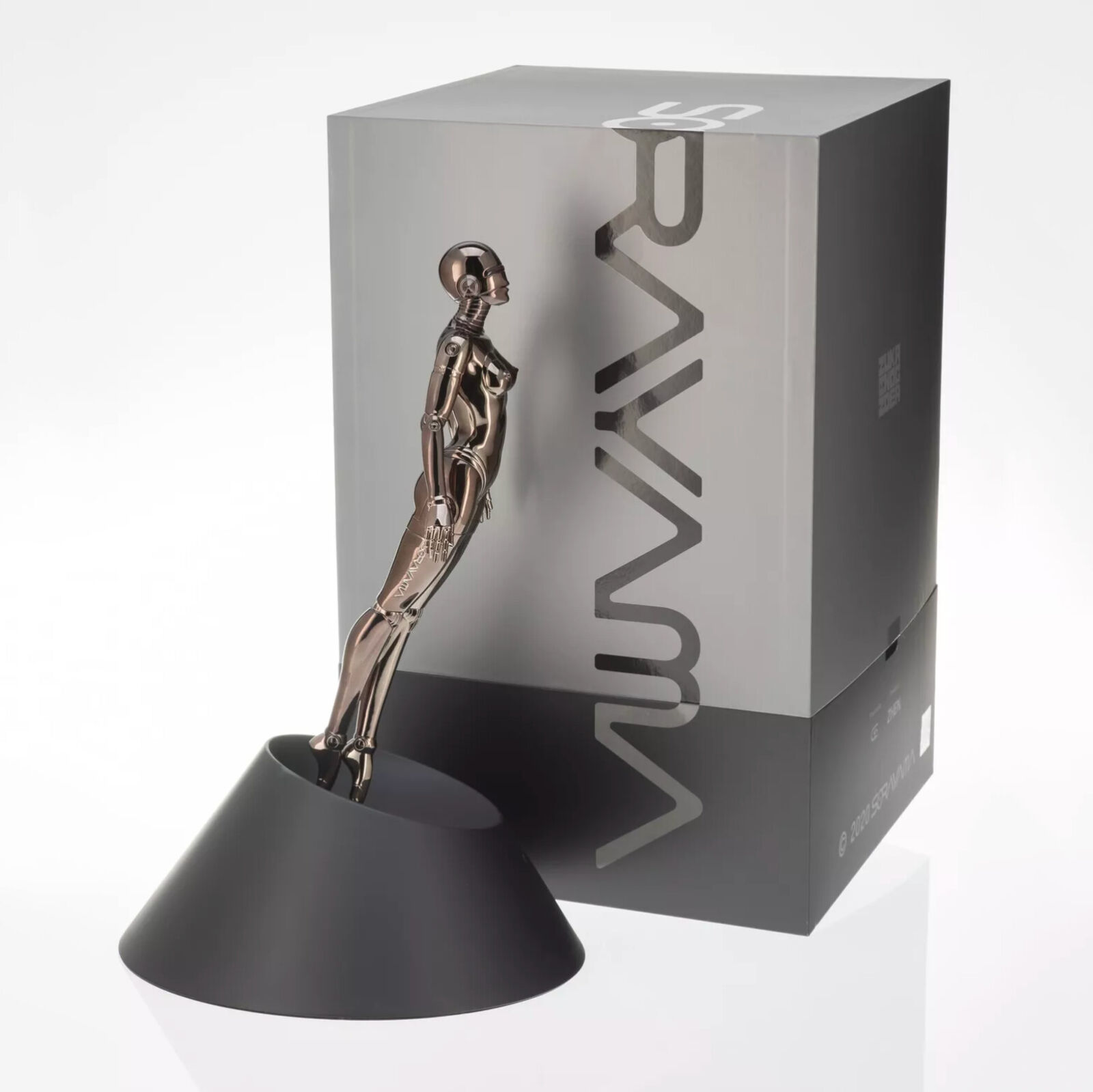 A metal sculpture of a woman standing on a black base.