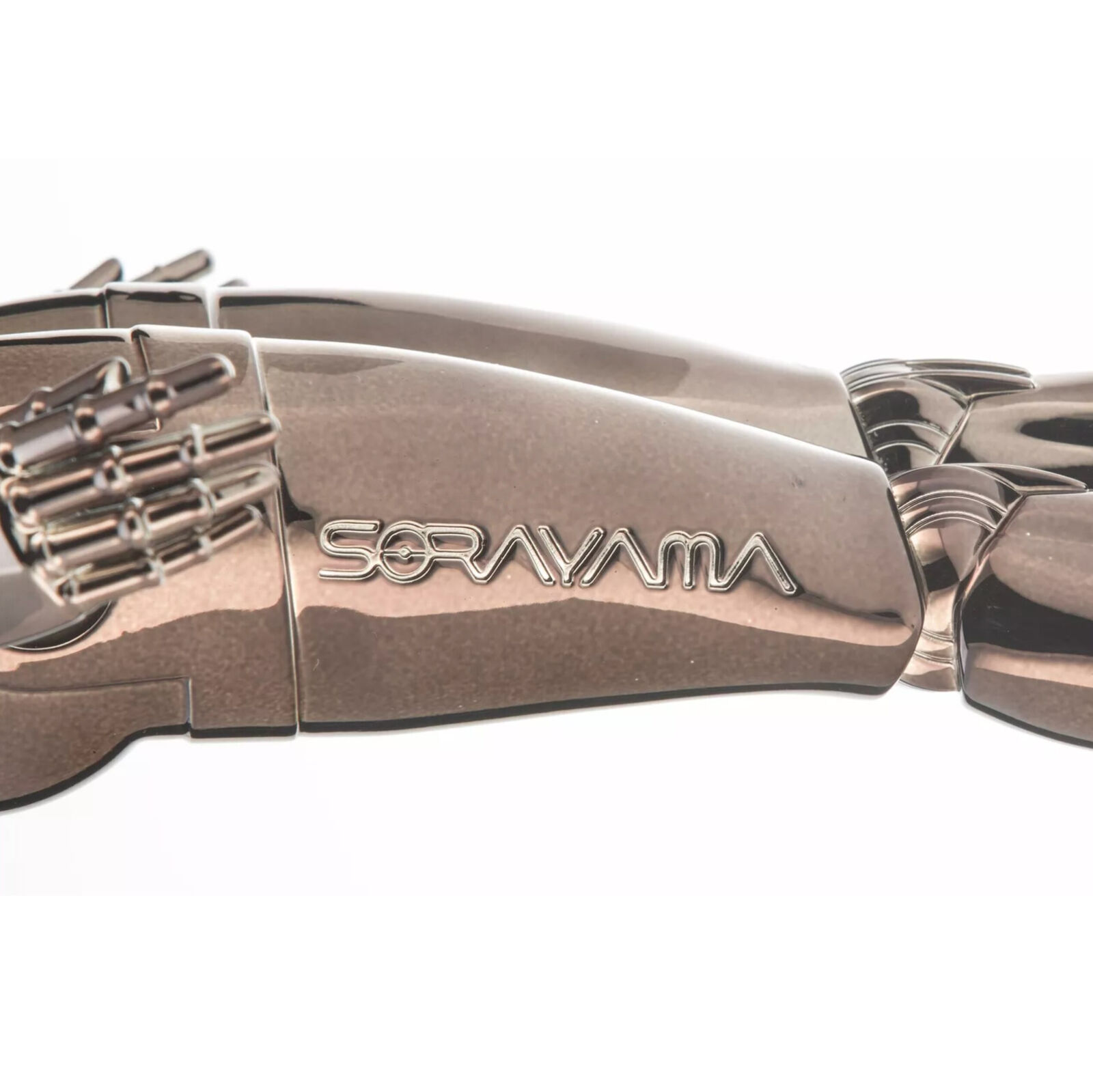 A metal sculpture of a woman standing on a black base.