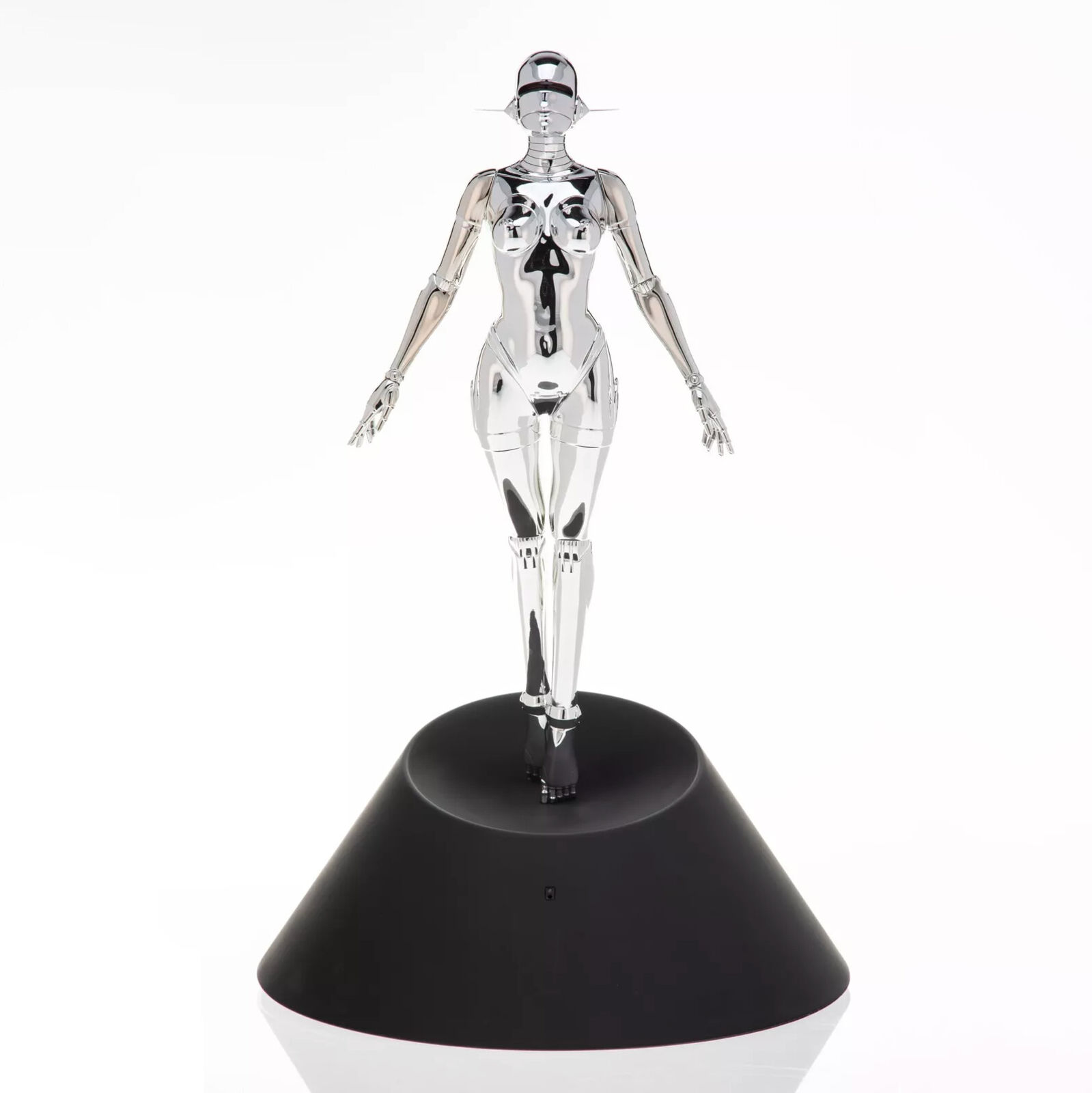 A silver robot figurine on a black base.