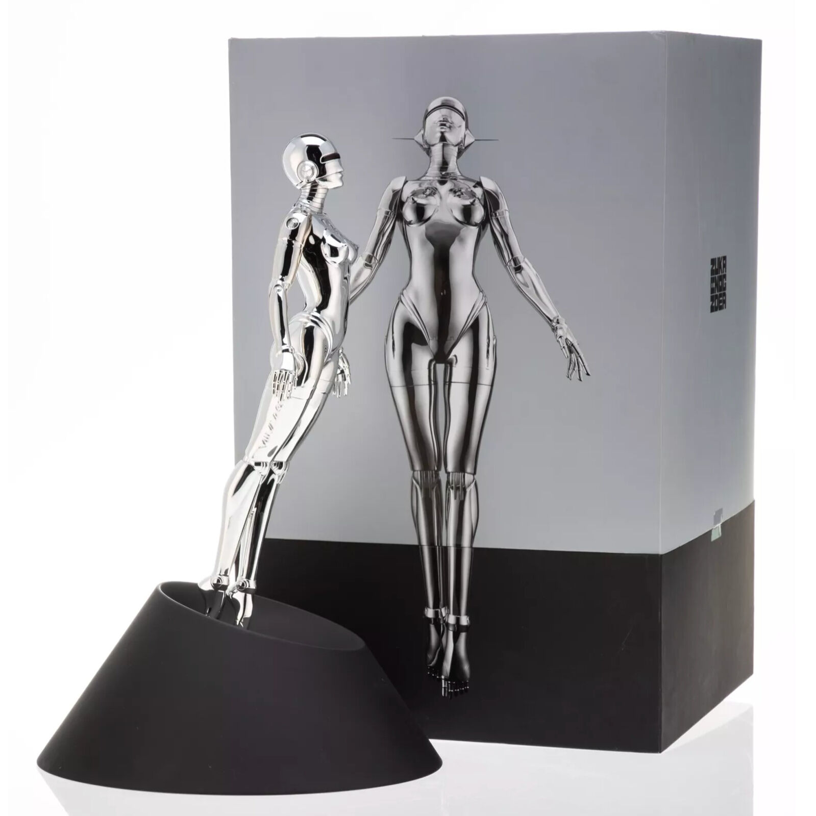 A silver robot figurine on a black base.