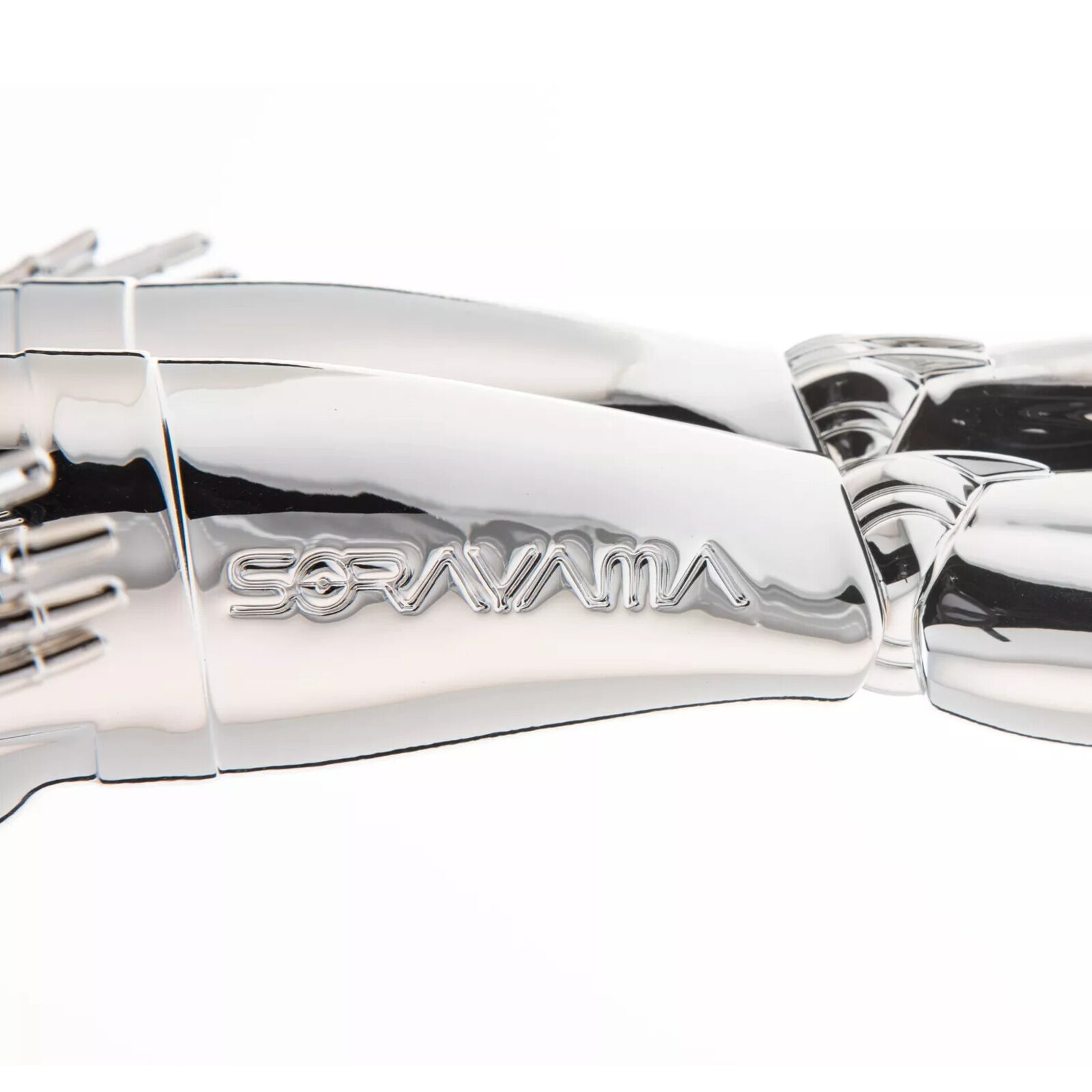 A silver robot figurine on a black base.