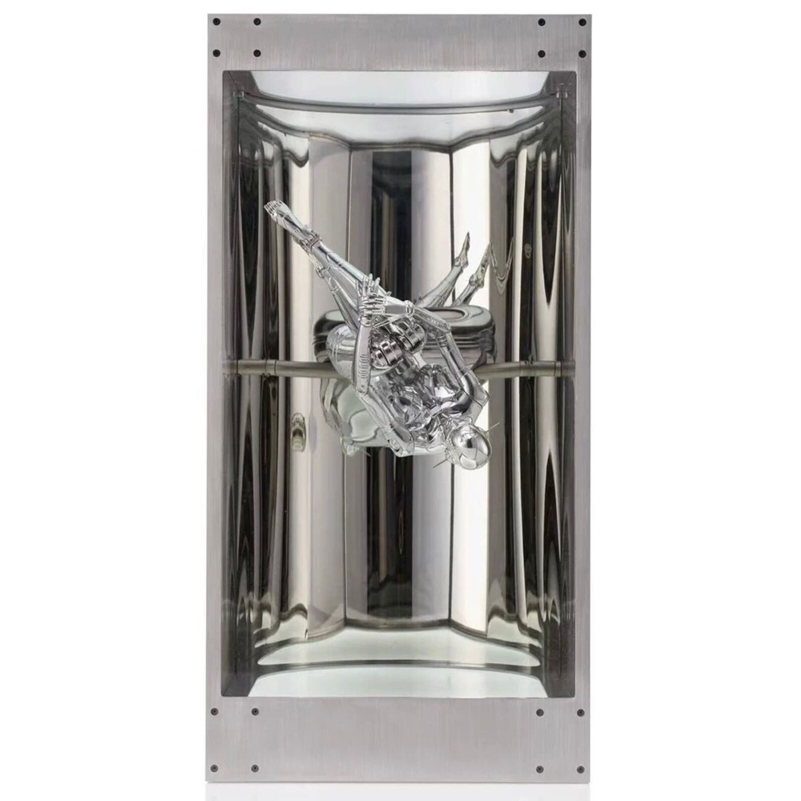 A metal sculpture of a gun in a glass case.