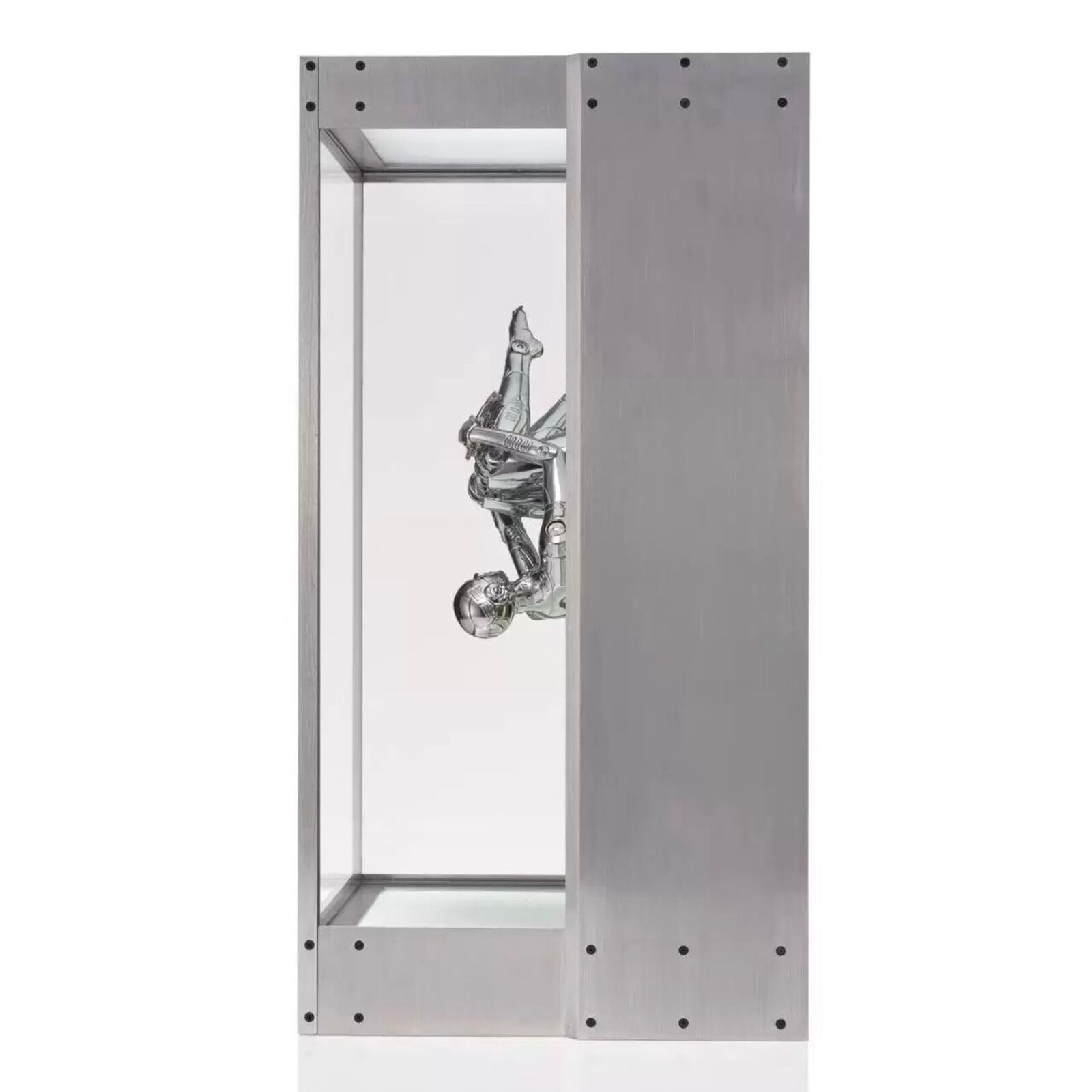 A metal sculpture of a gun in a glass case.