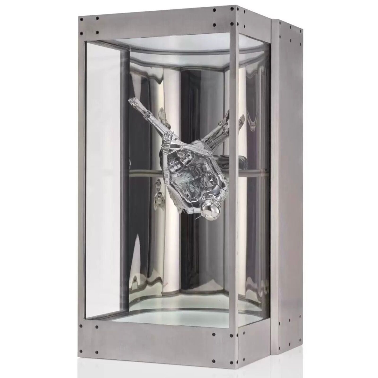 A metal sculpture of a gun in a glass case.