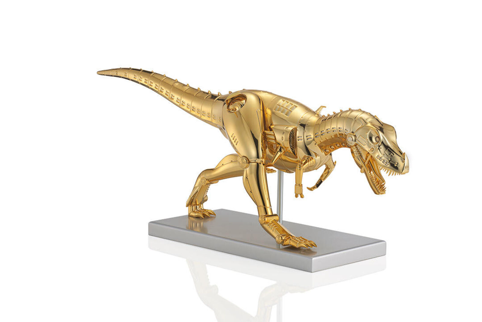 A gold model of a t-rex on a white background.