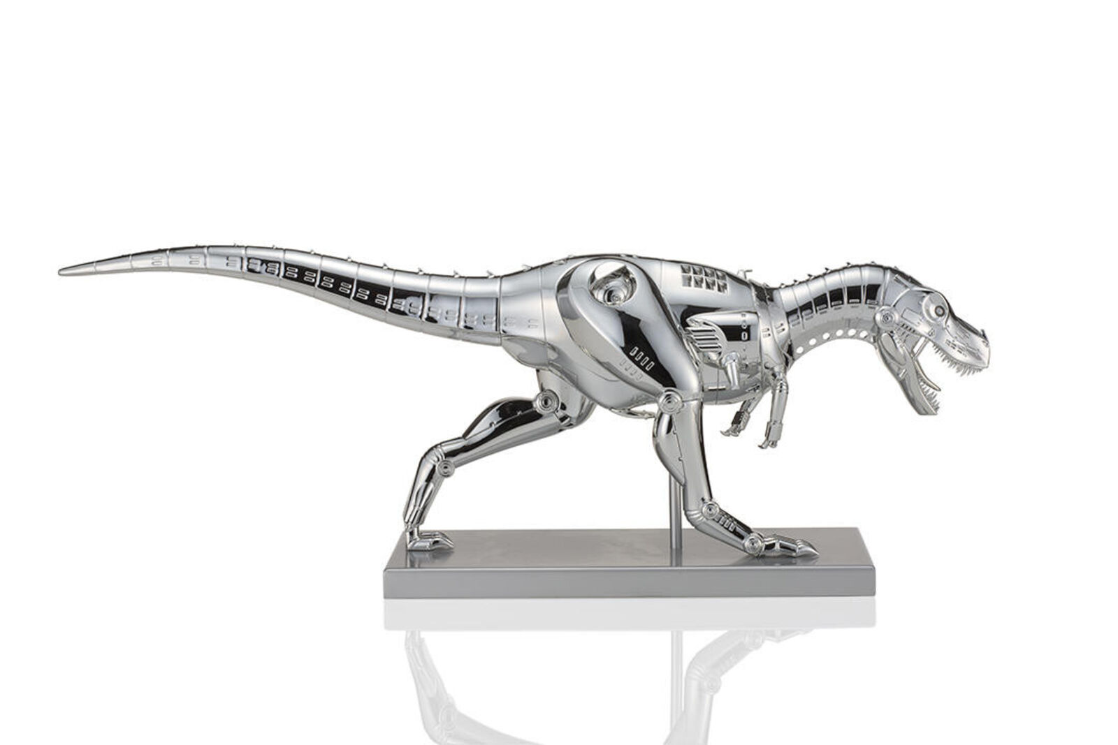 A metal model of a t-rex on a white background.