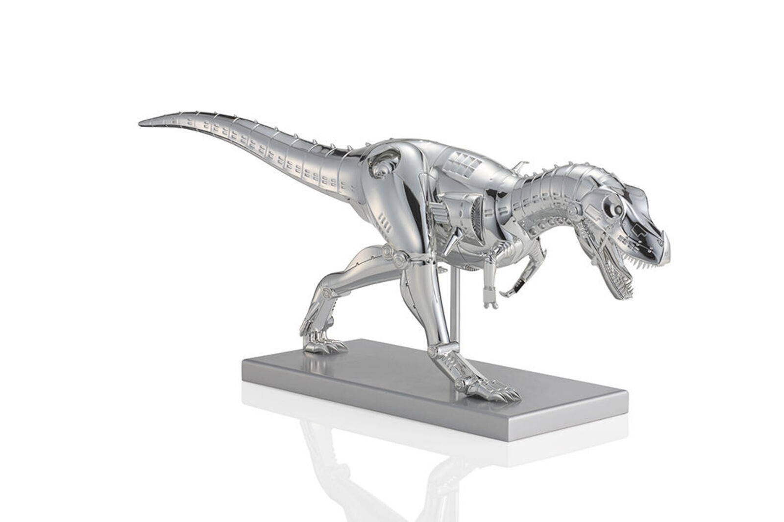 A metal model of a t-rex on a white background.