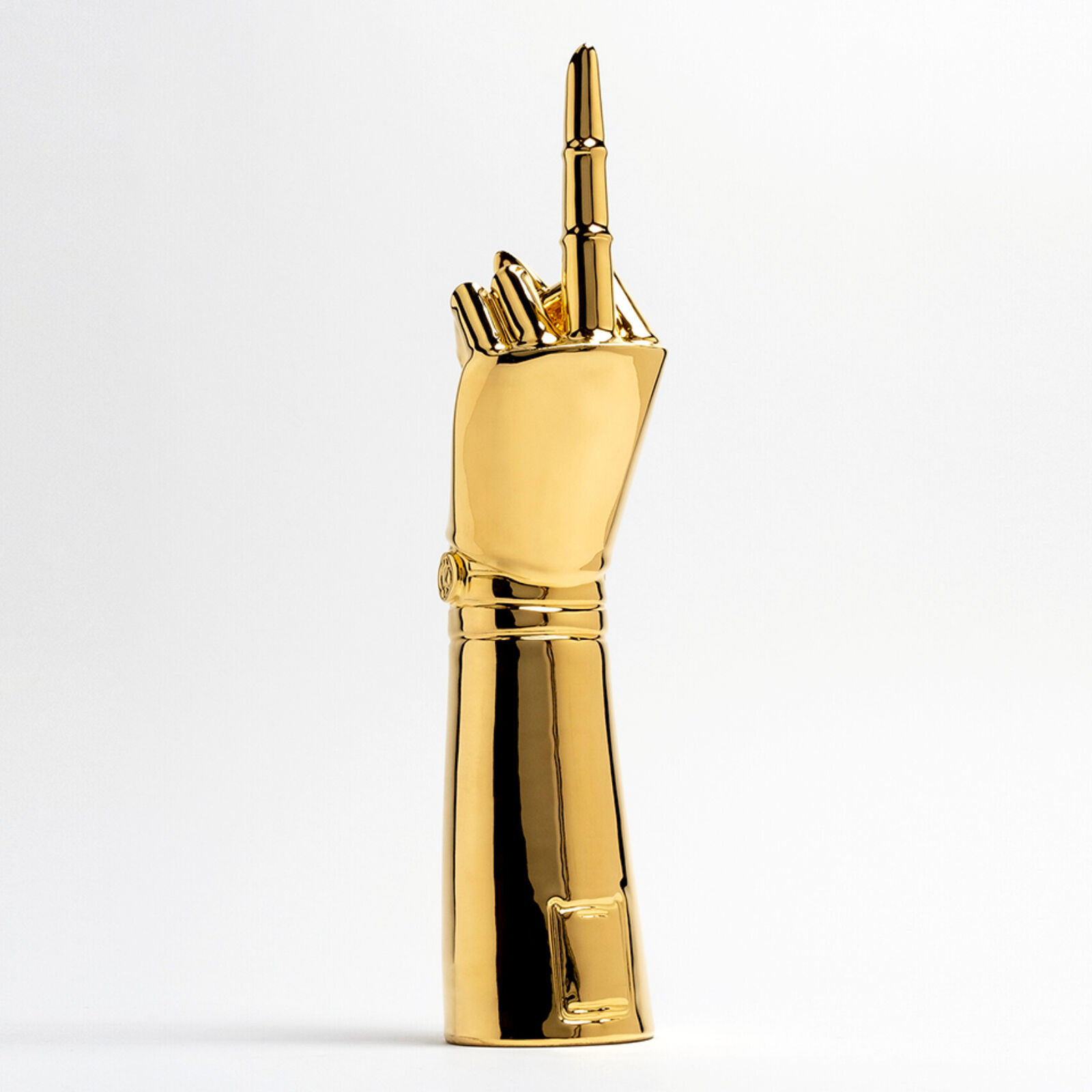 A gold statue of a hand holding a microphone.