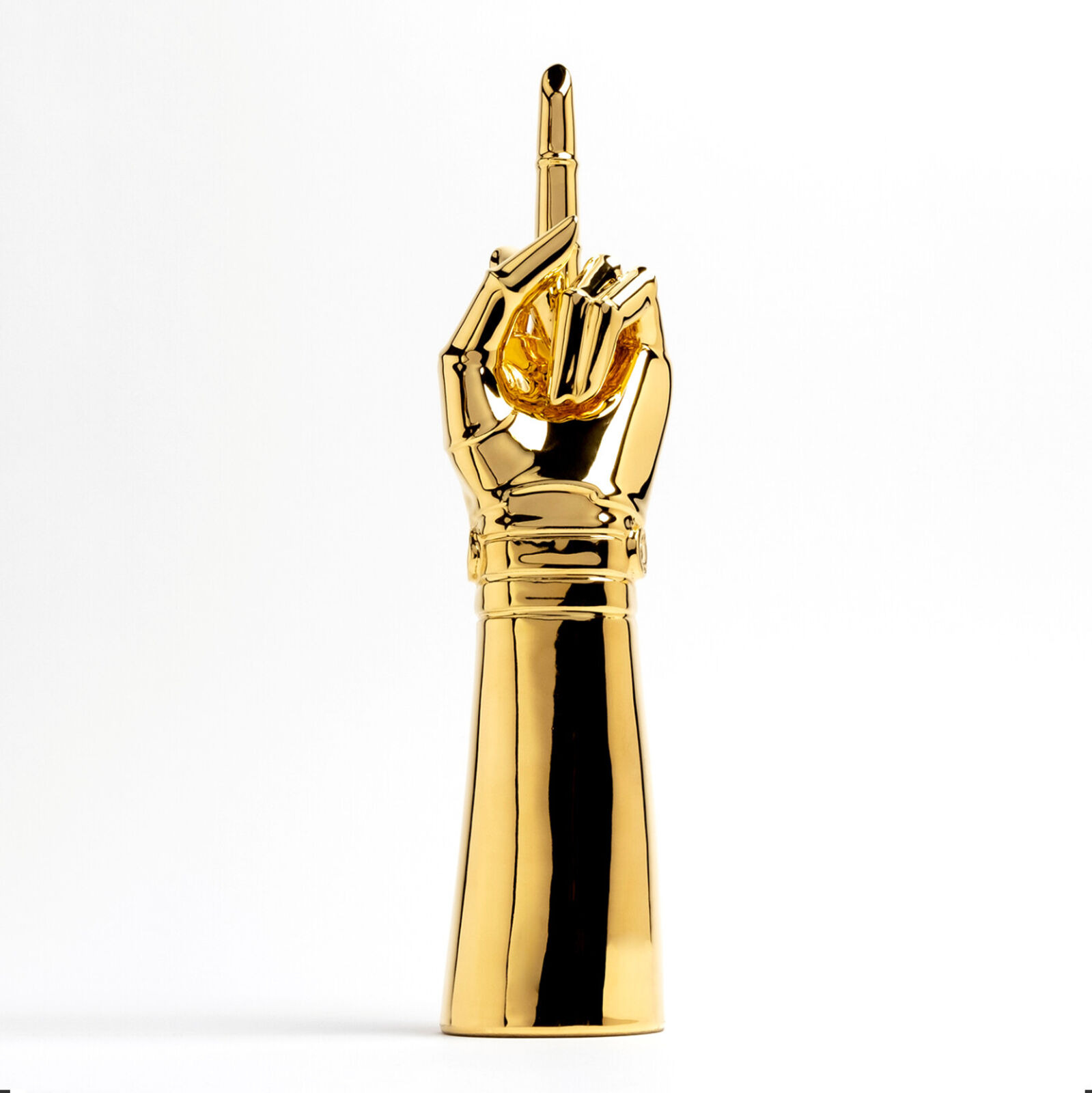 A gold statue of a hand holding a microphone.