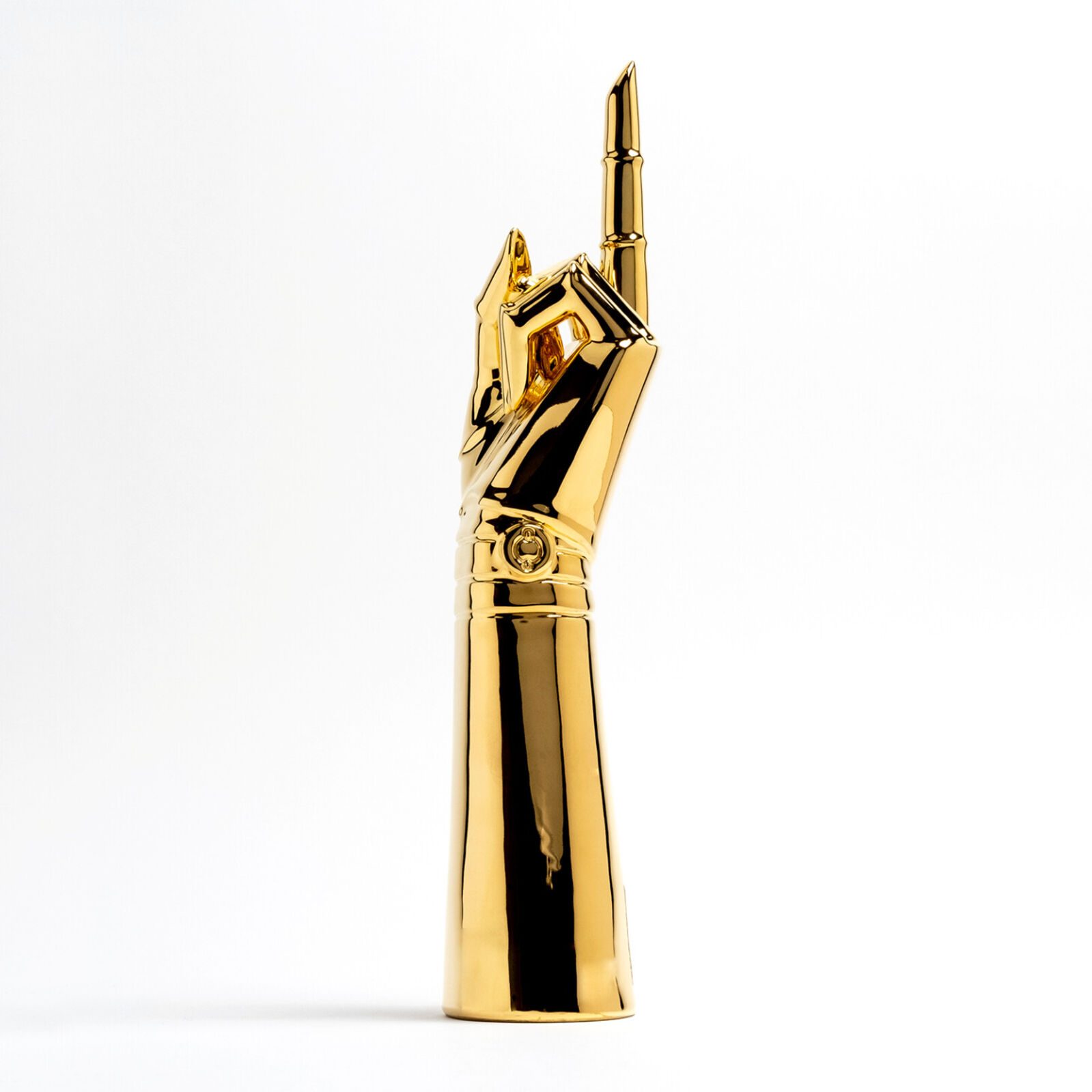 A gold statue of a hand holding a microphone.